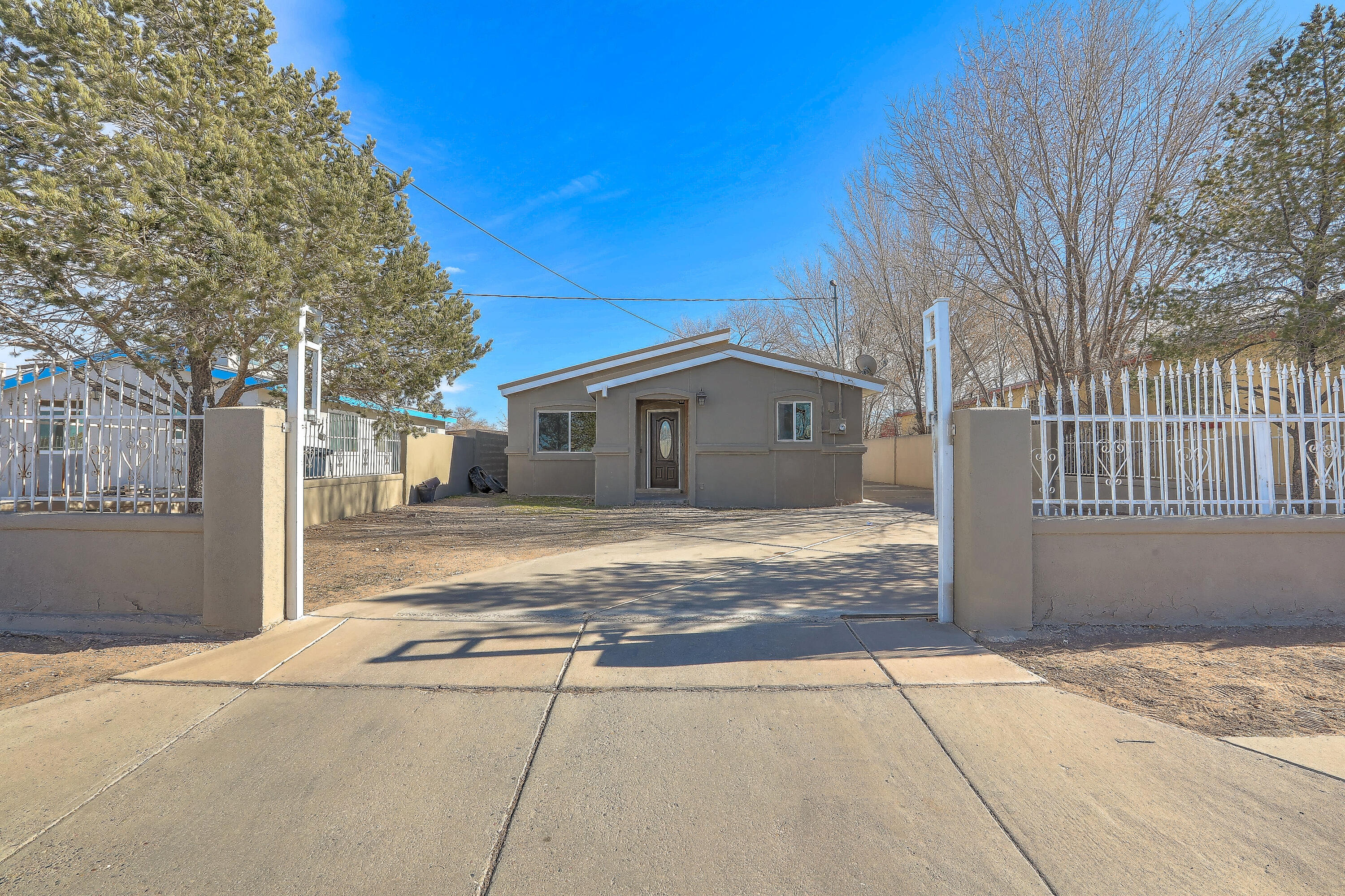 This stunning home in Albuquerque offers a spacious, modern open layout with high ceilings and abundant natural light. The updated kitchen features sleek appliances and countertops, perfect for cooking and entertaining. The primary suite includes a generous space with an en-suite bath. This home offers a full metal roof that provides longevity and durability with desirable backyard access. Ideal for RVs or extra parking. With a newly updated refrigerated A/C system, this home ensures comfort year-round. A perfect blend of style and function in a nice location!