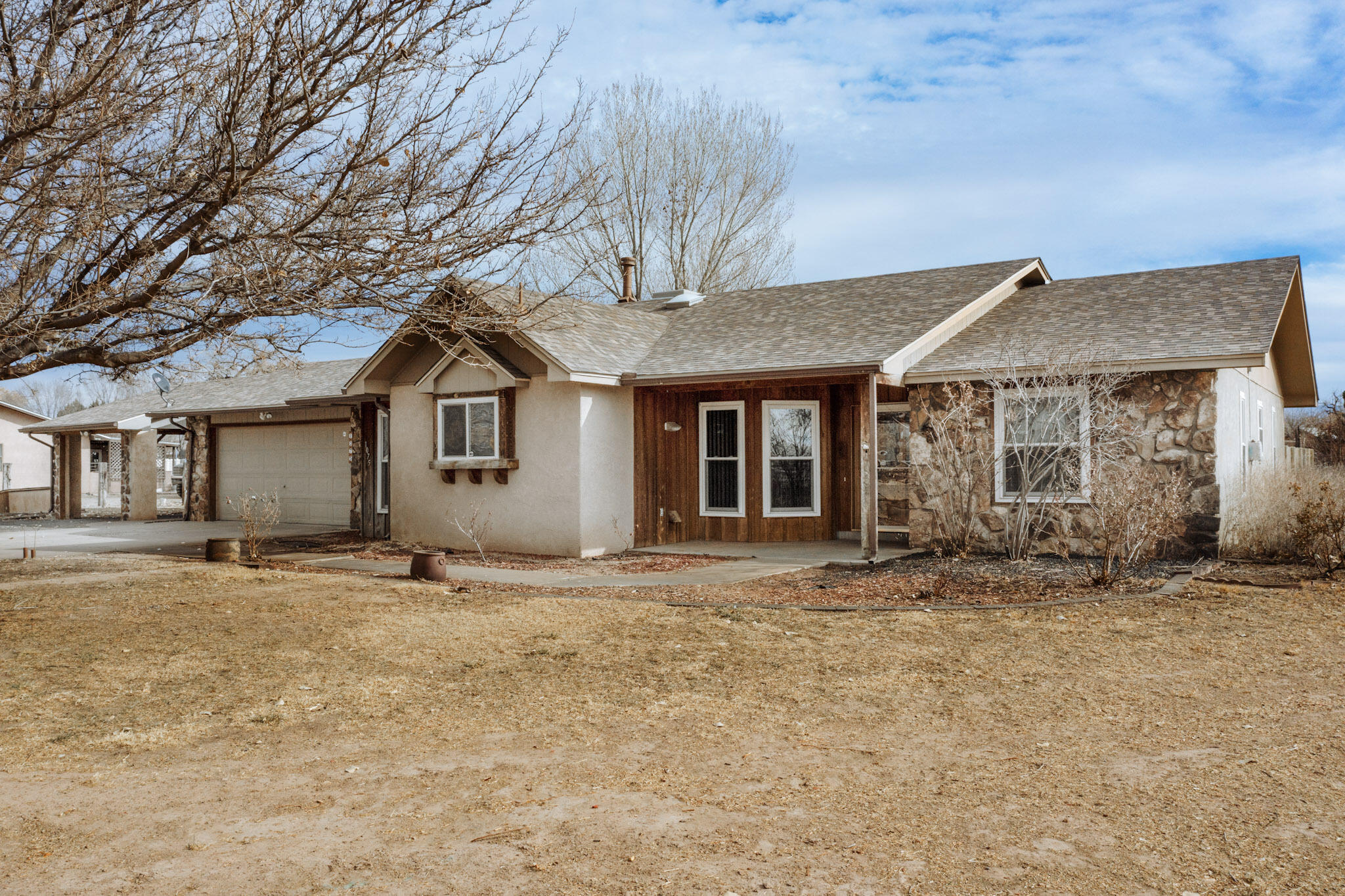 A outstanding location is the marque feature of this lovely 3 BR, 3 BA Bosque Farms home. Situated on 3/4 of an acre, across from spacious & wide open fields that host winter time waterfowl, this fully fenced property offers many desirable features in addition to it's peaceful and serene surroundings. The roomy garage is big enough for two cars, & there's more parking available for your toys, including a matching, detached carport. Enjoy private evenings in your  walled courtyard! Upgrades include a new roof in '23, connection to municipal water and sewer, brand new kitchen appliances, a new cooler, and a heated sunroom. Other adds include a irrigation well, updated windows, & a powered workshop off the garage provides space for hobbies or crafts! This is the place you've been looking for