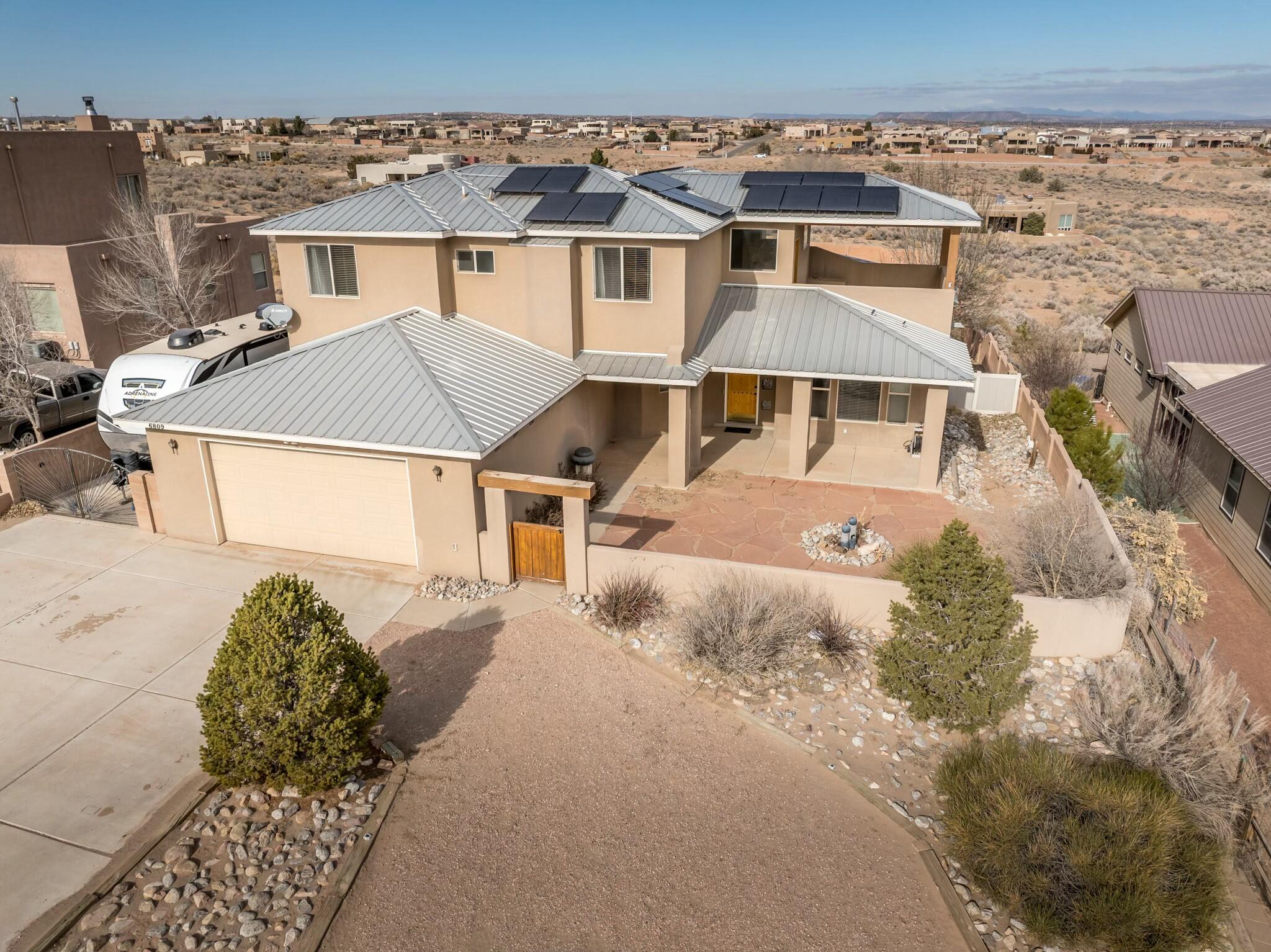 1/2 acre lot with Beautiful Views of the Sandia Mountains. Open concept from kitchen to Family room. Kitchen is very spacious and big with lots of cabinets, granite counter tops, and island. Family room has two story high ceiling in it. Large master bedroom and bath. Master is on main floor. There is a gate to back yard access and RV parking, plus RV hookup to electric. 3 car extra large garage w/one bay on side of home. Large concrete back yard porch/patio to enjoy lots of company. Huge back yard with lots of real grass, basket ball court, and area that could be volleyball court or used for other things. Both front and back yards are totally fenced in with block walls. This is a beautiful, spacious home! Take a look and see for yourself. Solar panels newer. Some new appliances.