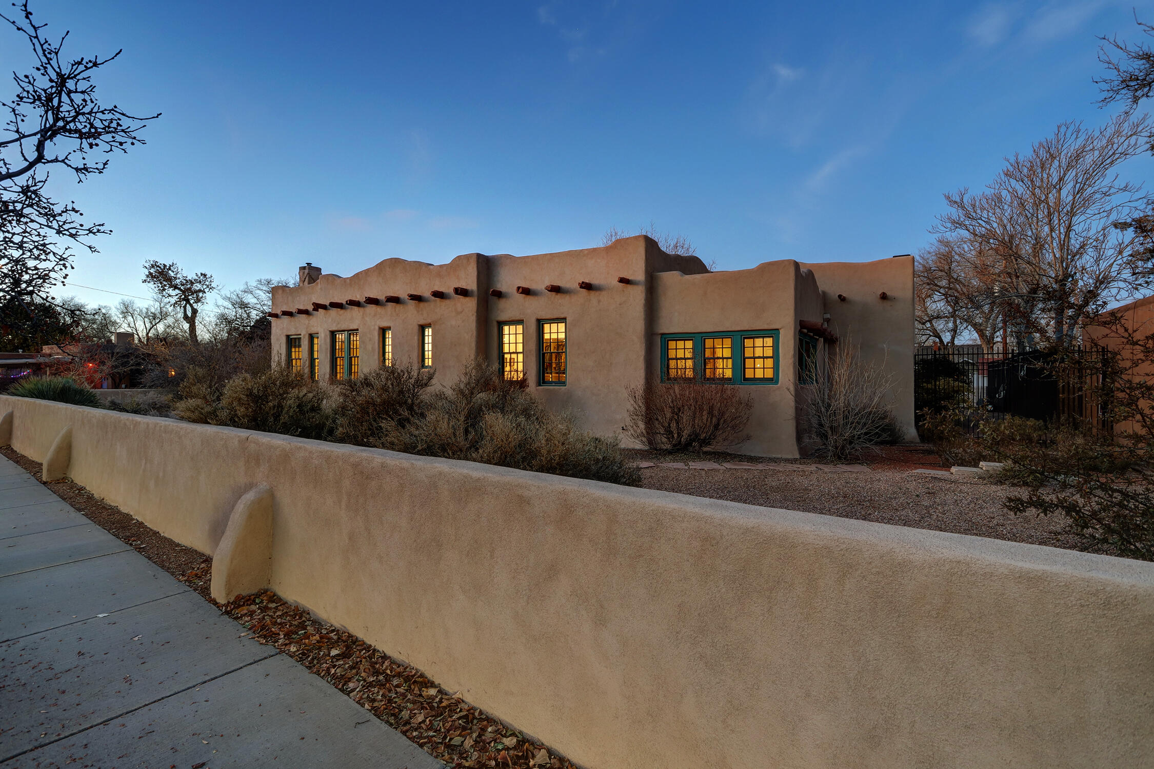 The opportunity to own the Whitmer-McKinnon house, embodying Pueblo Revival, Mission, and art deco styles, and lovingly restored and updated by the current owner, is here. Built around a traditional center courtyard, or placita, with enclosed portal, this sunny, spacious, and warm home has historical bona fides and modern conveniences to spare. Design work by Strell Design, remodeling by Mike Hatchell, and touches such as a custom Skinner-Jones mural, combine with vintage beauty - light fixtures from the Alvarado Hotel, for instance - to make a unique, gorgeous, and comfortable home. Here you'll find an oversized 2-car garage with storage, a multi-generational floorplan, walk-in closets, owned solar panels, double paned windows, butler's pantry, and indoor/outdoor living. Gorgeous!