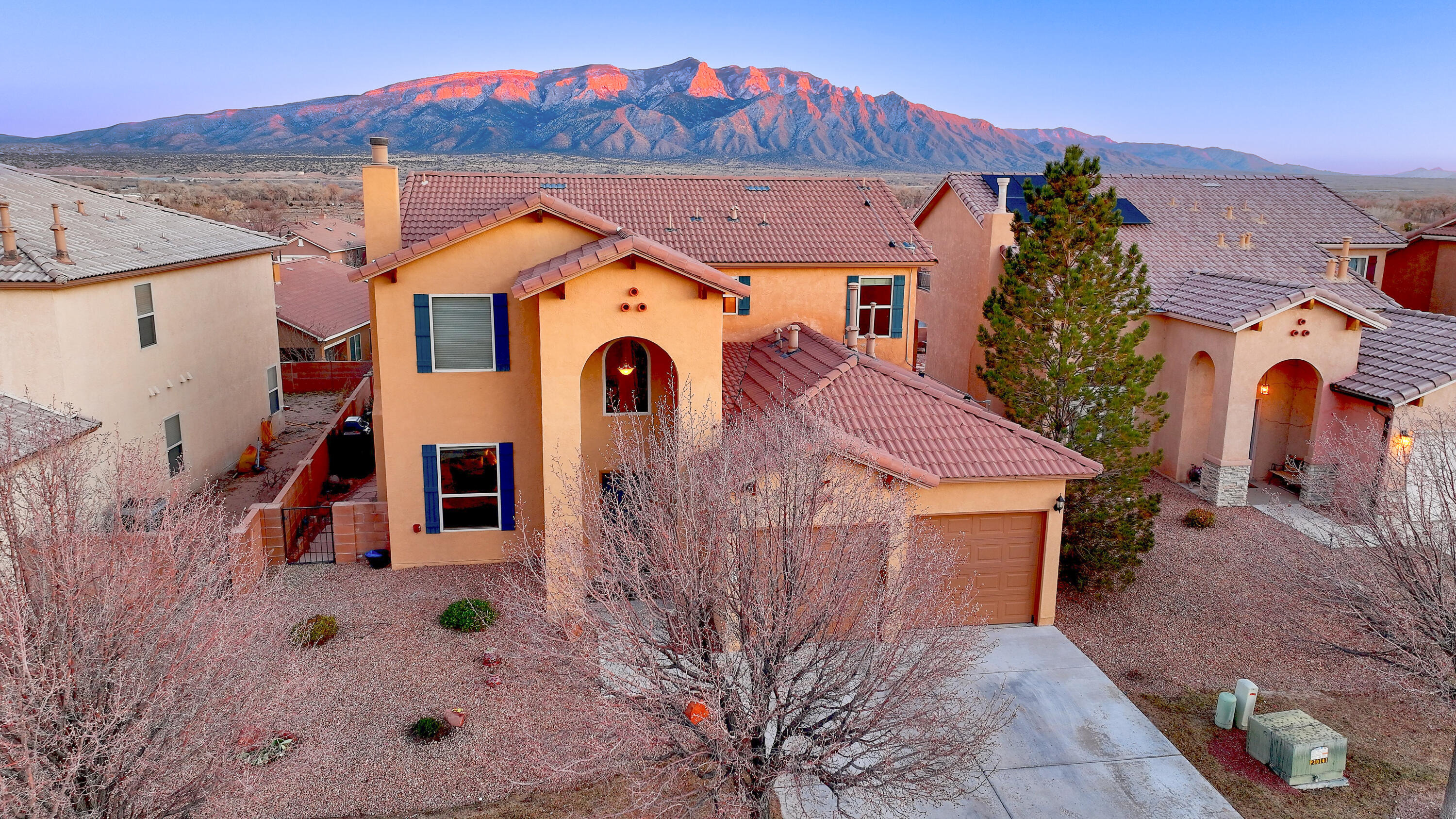 Experience breathtaking Sandia sunsets bursting in vibrant shades of red and purple from the privacy of your wisteria-covered pergola. This pristine home, meticulously maintained, shines with elegance and style. Gleaming engineered wood floors enhance the living and dining rooms, while soaring vaulted ceilings and abundant windows fill the space with natural light. The kitchen boasts granite countertops, updated stainless steel appliances, and a charming breakfast nook with stunning views.The spacious downstairs master suite provides ultimate convenience and privacy, while a huge upstairs loft offers a flexible second living space or a retreat for extended family. Step onto the second-floor balcony to savor panoramic mountain vistas and peaceful evenings.