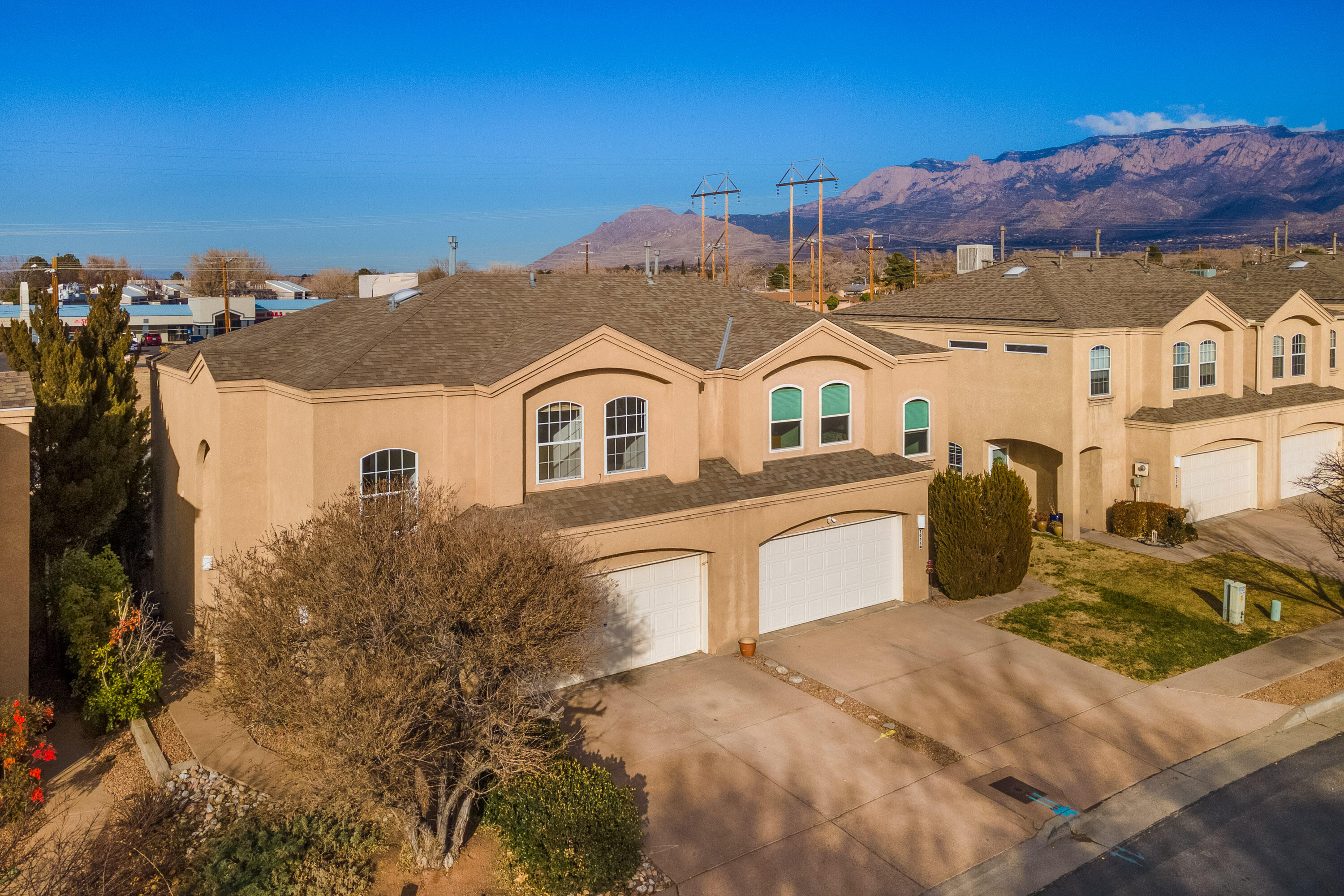 This beautifully maintained townhome combines modern convenience with an unbeatable location. Nestled in the heart of the city, it's just minutes from top-rated schools, popular dining spots, and vibrant shopping centers, ensuring everything you need is always within reach. The spacious primary suite features a private upstairs patio, offering breathtaking views of the Sandia Mountains--perfect for relaxing mornings or serene evenings. A recently replaced roof and a low-maintenance yard provide peace of mind and easy living. This home is an ideal retreat for those seeking style, comfort, and accessibility in one package. Don't miss this opportunity!