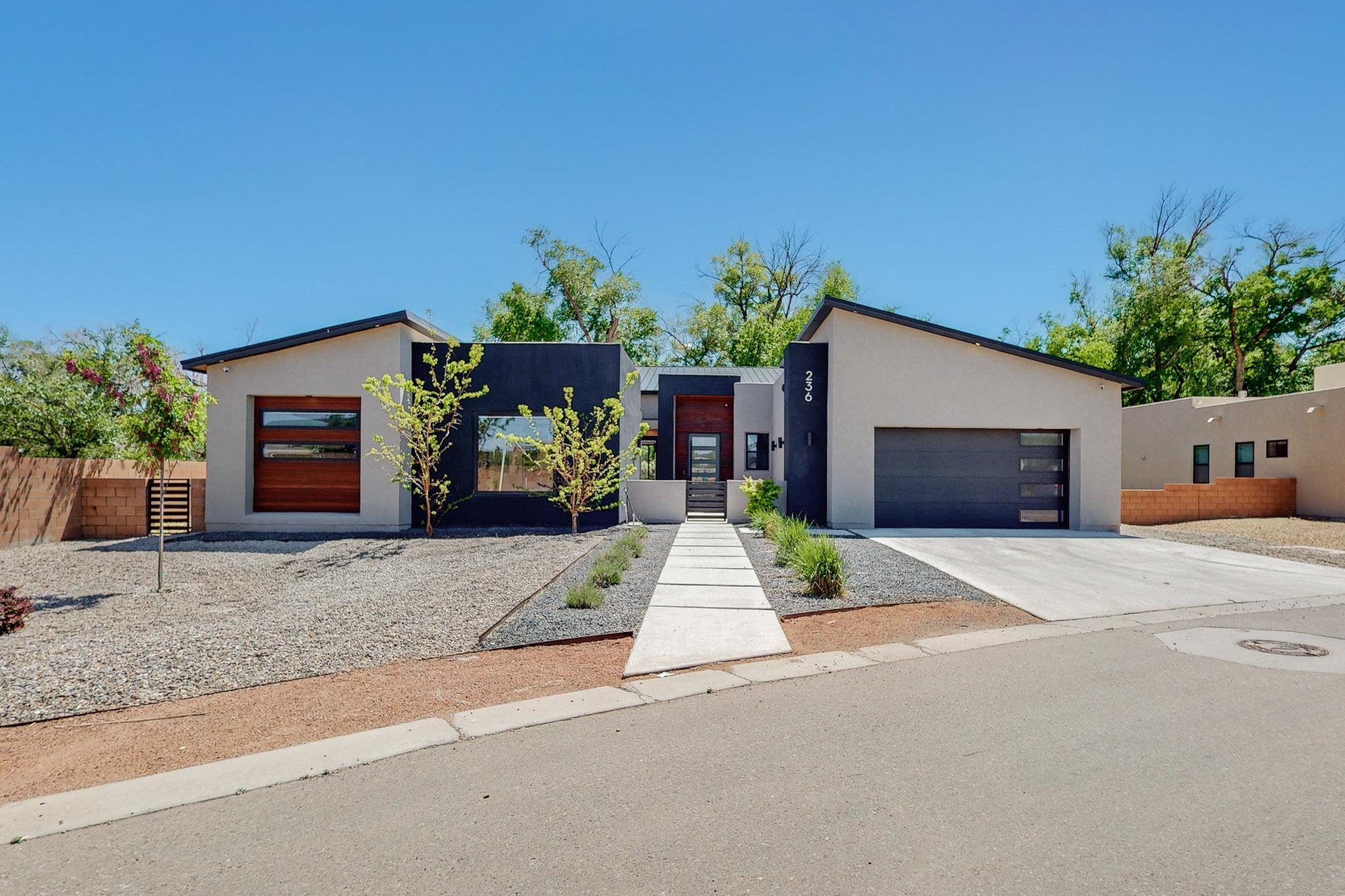 Contemporary home conveniently located in the heart of the north valley! This beautifully-designed home is full of unique upgraded features including surround sound speakers, Andersen windows, tankless water heater and water softener. Living room boasts up to 17' tall ceilings, a 5' linear fireplace, unique aspen log accent, and a 12' door that pockets all the way into the wall! Kitchen has all drawers, Thor appliances, a hidden pantry, touchless faucet with workstation sink and reverse osmosis water station! The suite bathroom has gorgeous custom tile work with a black freestanding tub and large open shower.  Extra large pull-through 3 car garage with plenty of storage.  Built-in grill and interior courtyard with outdoor gas fireplace highlights the outdoor living spaces.