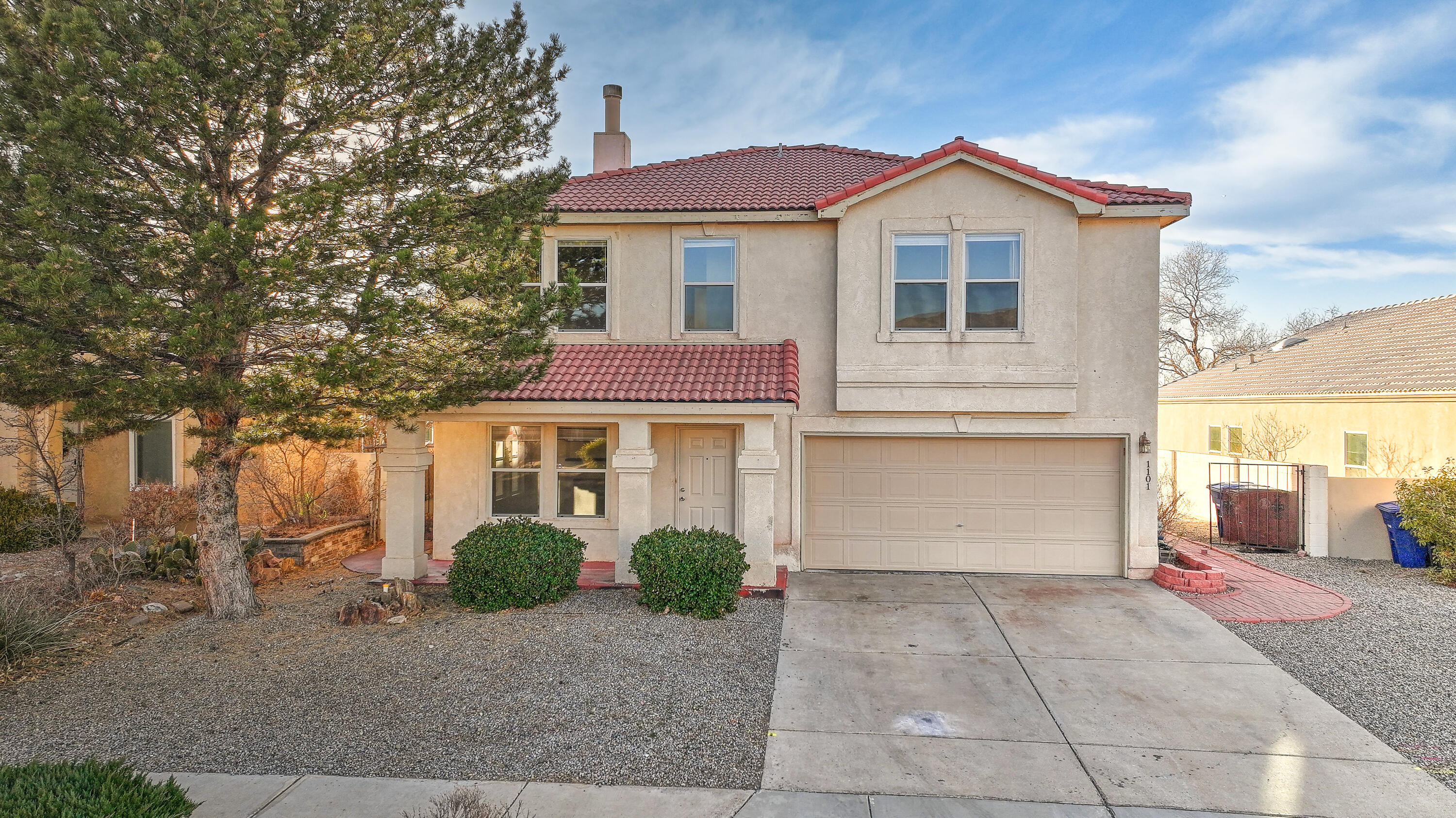 Fantastic opportunity to own a 4 BR home in Willow wood, with wide sidewalks, hiking trails and access to Manzano Mesa multicultural center!  This home features an open layout with two living areas and a double-sided fireplace on the main level, along with a kitchen with stainless steel appliances, a breakfast nook and westward views.  All bedrooms are upstairs, generously sized, most with walk-in closets and ceiling fans.  The hall bathroom sports new tile flooring and shares a door with one of the bedrooms.  The primary suite has two walk-in closets plus a luxurious bathroom with a garden tub and separate shower.  The private backyard has amazing westward views + a covered patio made of big wooden beams, and a nook with a fridge and granite countertop, and a large storage shed.