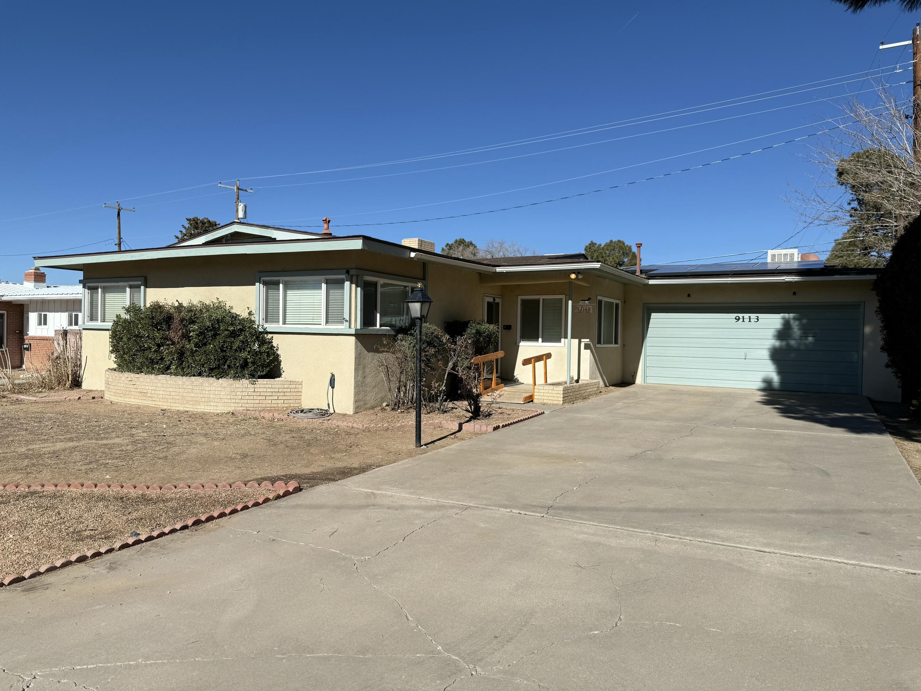 This charming 3-bedroom  2-bath home is ideally located in the Belhaven area, close to Kirtland Airforce Base, just minutes from I-40, Sandia National Labs, and UPTOWN, offering an abundance of shopping and restaurants. The kitchen is equipped with plenty of cabinets and a window space that opens into the sunroom, creating a spacious layout. You can stay comfortable during the winter months with the gas fireplace. The outdoor space features a covered patio and offers a blank canvas for your creative ideas. Additionally, there is a shed available for storing extra item.  This home a prime choice for comfortable living. Freshely painted and new carpet to be installed in bedrooms.