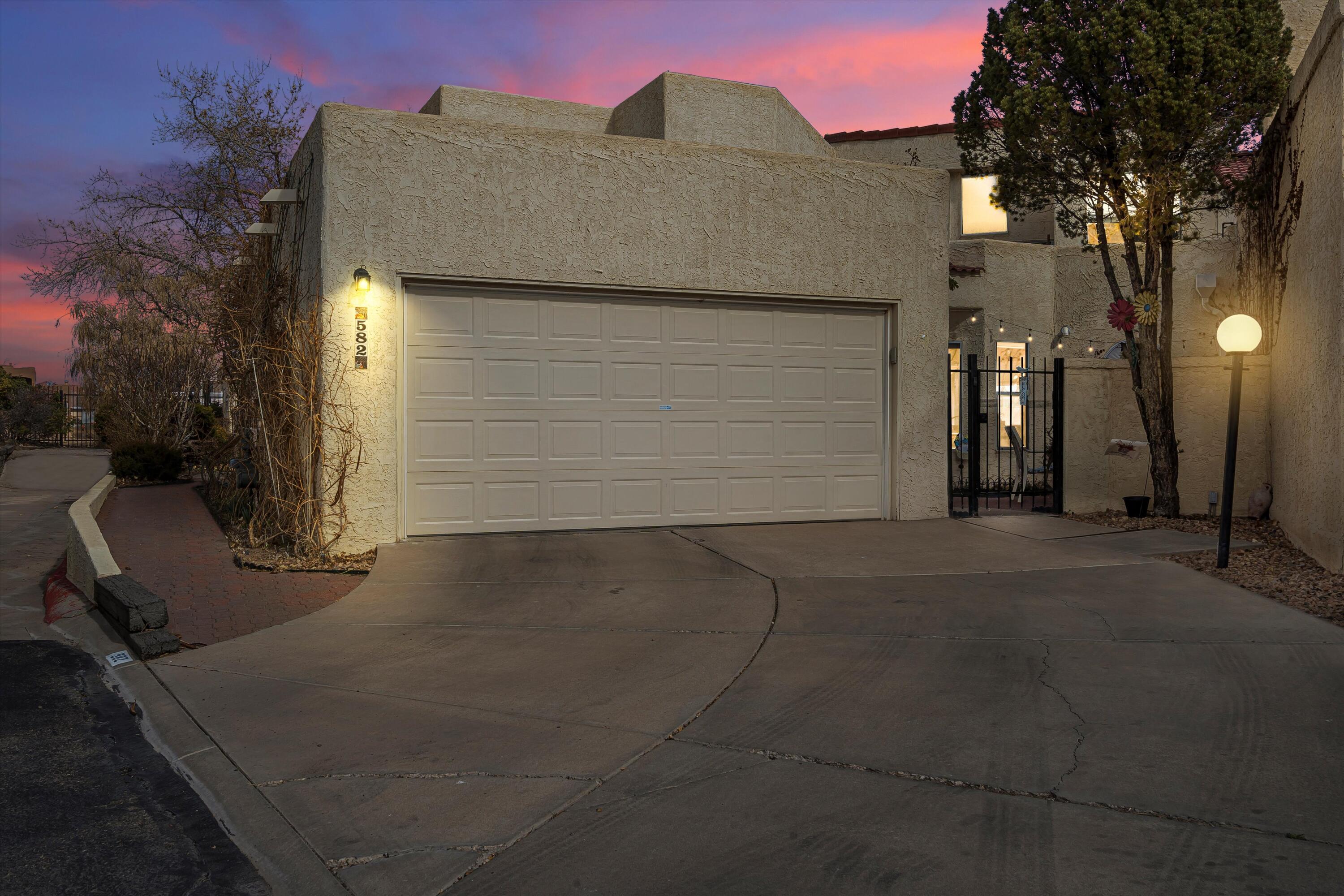 This hidden Beautiful Gated Community is a true gem! Whether you are looking for a year-round residence or a lock and leave property, this is the one for you! Tucked away on a corner lot with beautiful views of the Sandia Mountain. With the primary bedroom downstairs along with a second room which is currently being used as an office but has options to be anything your heart desires from an art studio, yoga/workout room, or just a second bedroom. Let's not forget about the second primary bedroom upstairs with a gas log fireplace and a private balcony, perfect for company! This home shows pride of owner ship and is conveniently located near grocery stores, restaurants, and so much more you do not want to miss out on this home! HOA covers water/sewer, streets & common areas.