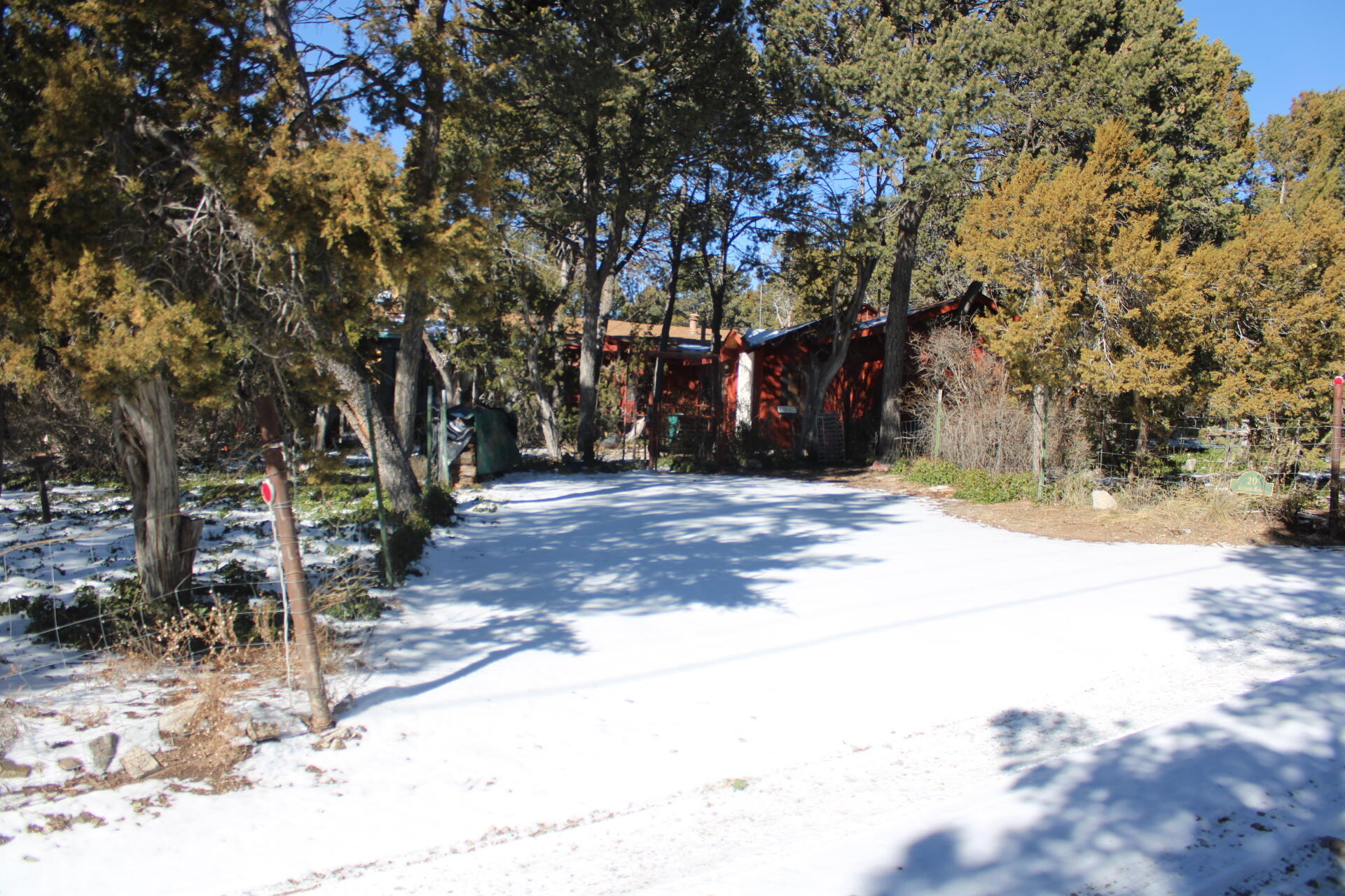 Come home to this serene, wooded retreat with a unique blend of tranquility and potential. The property features a charming main dwelling, a greenhouse, detached garage, shed, and lots of storage . There are two water wells on the property. There's an incomplete accessory dwelling unit, for an exciting opportunity to build into a second income space, office, or art studio--perfect for those seeking creativity or extra income potential.In need of storage? A large storage area is also available, providing ample space for your belongings. There is a short walking trial at the top end of the property. This property is a true nature lover's paradise, offering both a peaceful retreat and endless possibilities for growth and customization. About 40 min to ABQ and 60 min to Santa Fe