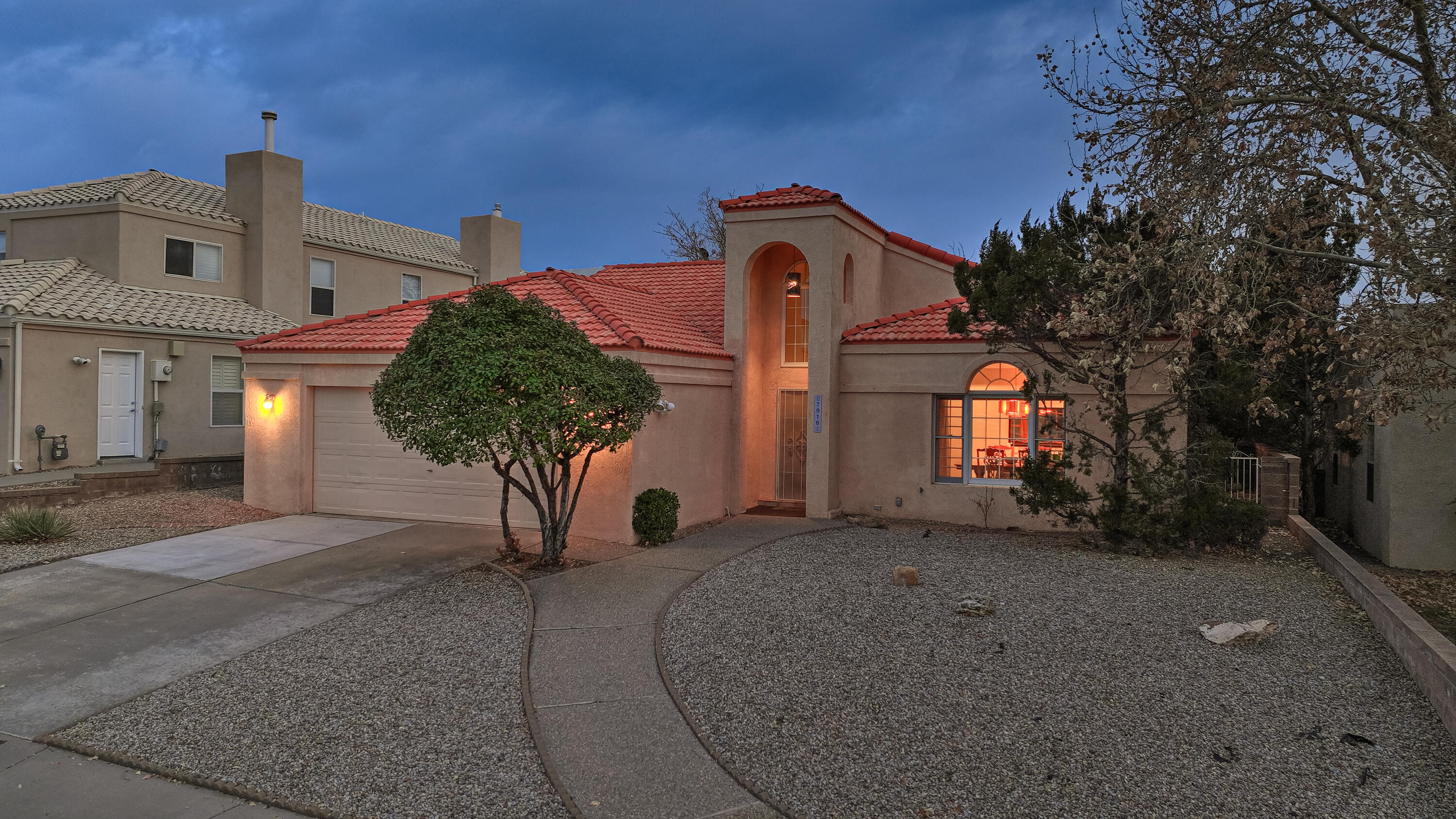 Light, Bright, and Beautiful One-Story in the NE Heights - Step into this stunning former RogerSmith Homes model, designed with elegance and practicality in mind. This home features raised ceilings and wood-framed windows that fill the space with natural light, creating a warm and inviting atmosphere. The thoughtful layout includes a covered patio and a landscaped yard, ideal for outdoor entertaining or quiet relaxation. Pet lovers will appreciate the custom-built catio, which can be easily removed. One block from La Cueva HS and situated in highly desirable school districts, this home offers both convenience and top-tier education opportunities. You'll also love being close to shopping and dining options in the vibrant NE Heights.