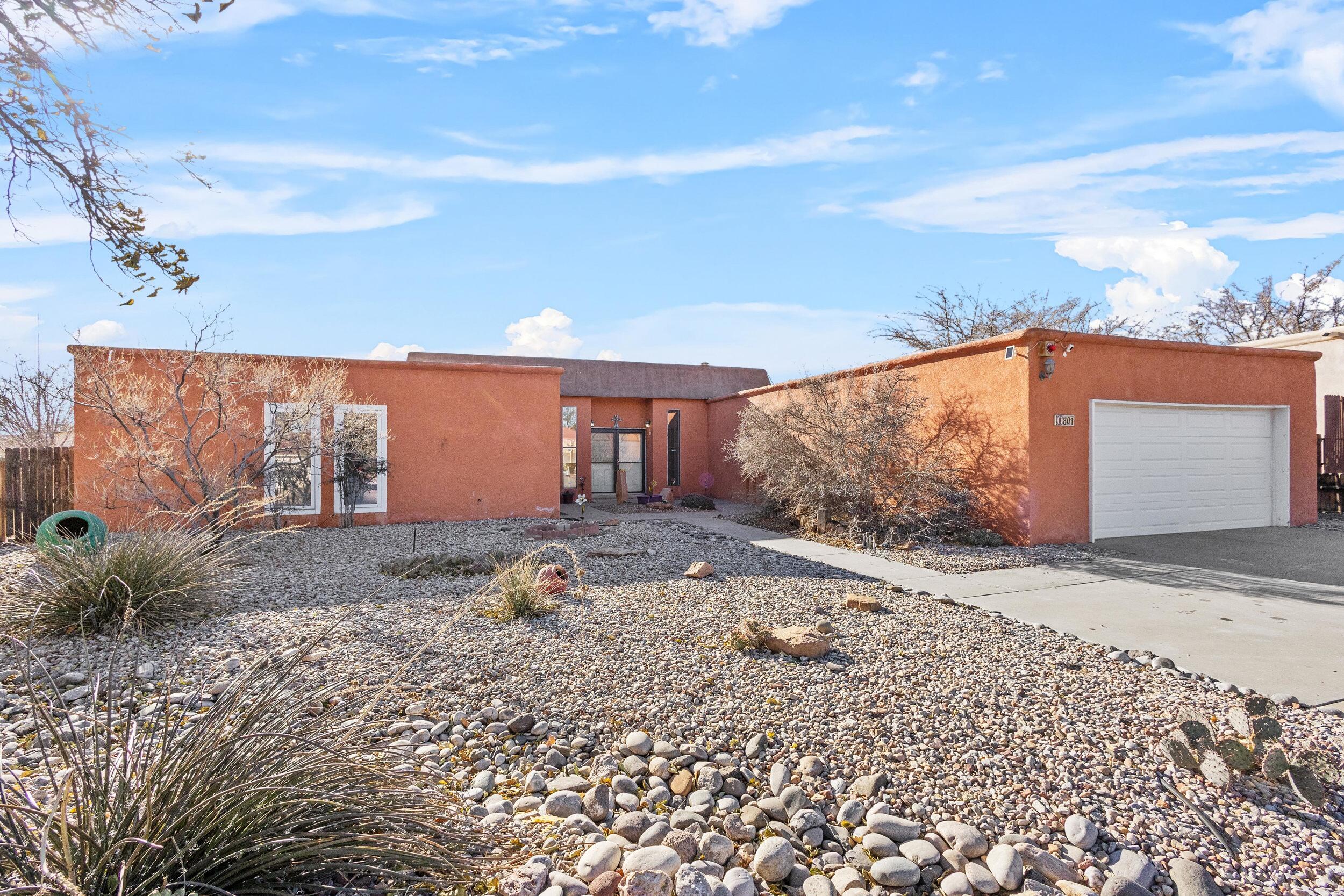 This elegant residence showcases classic Southwest architecture, featuring a grand living area adorned with traditional wood paneling, Hurd wood windows, vigas, & a charming fireplace flanked by built-in cabinets. The updated kitchen is both functional & stylish, & a cozy breakfast nook.The spacious primary bedroom serves as a tranquil retreat, complete with a remodeled en-suite bathroom & direct access to a private backyard patio. Your oversized lot provides privacy & security, & includes three patios & a wood pergola--ideal for outdoor relaxation & entertaining. Additional features include a generously sized laundry room & an oversized garage, enhancing the home's practicality Situated conveniently near shopping centers & transportation routes. Don't miss this one!