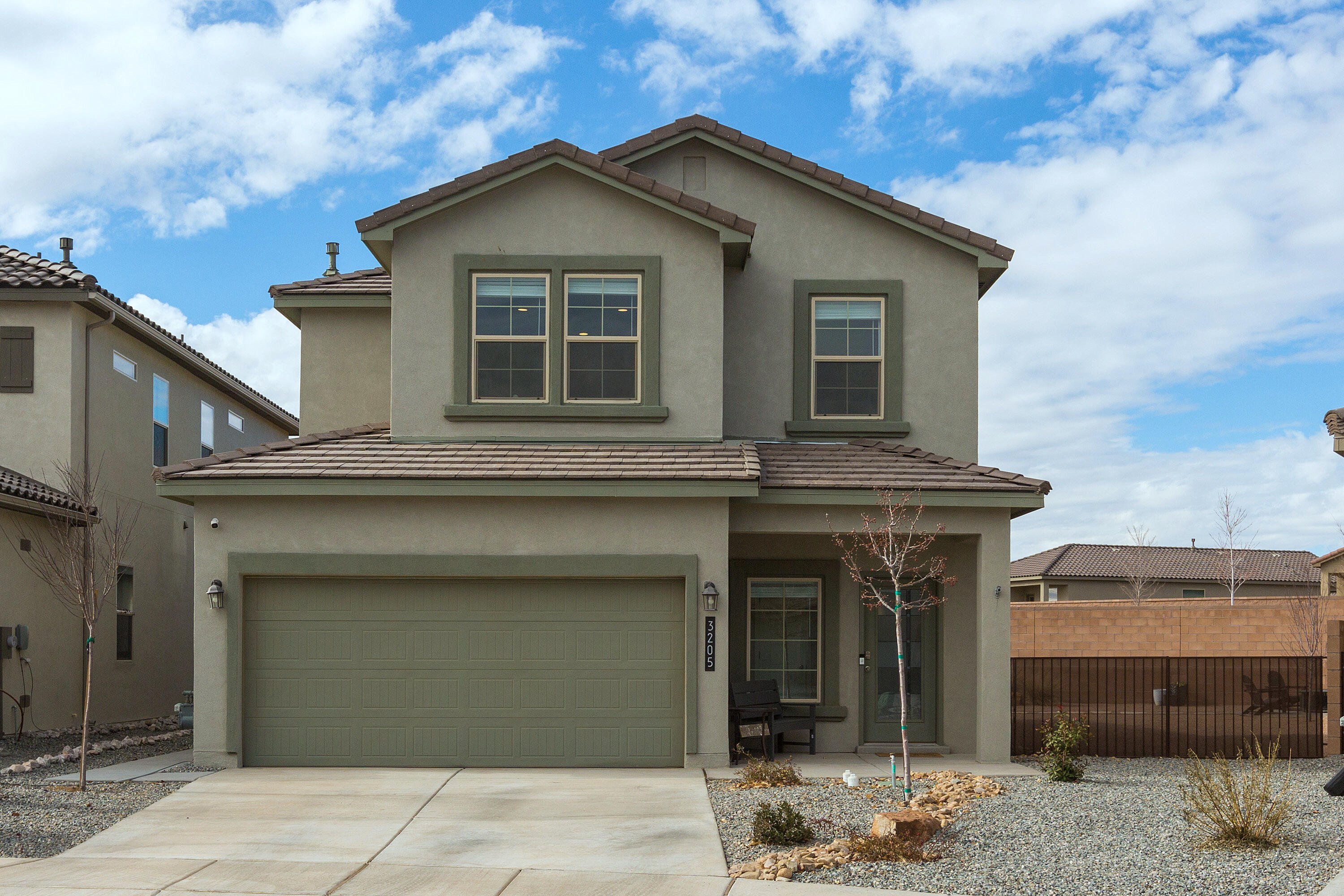 Discover this meticulously maintained 4-bedroom, 2.5-bath home on a premium pie shaped lot with fully landscaped front and back yards. The spacious, open-concept design seamlessly connects the contemporary kitchen--featuring quartz countertops, Whirlpool stainless steel appliances, a walk-in pantry, Island all open to the dining and living areas, perfect for entertaining. The primary suite, located on the main floor, includes a custom closet and a luxurious bath with a walk-in shower. Upstairs, enjoy a versatile loft/den, three bedrooms, and a full bath. Amazing views of the Sandia Mountains from the loft/den. This home is truly ''Move-in Ready'' combining style and comfort in an unbeatable location near shopping, dining, and hospitals.