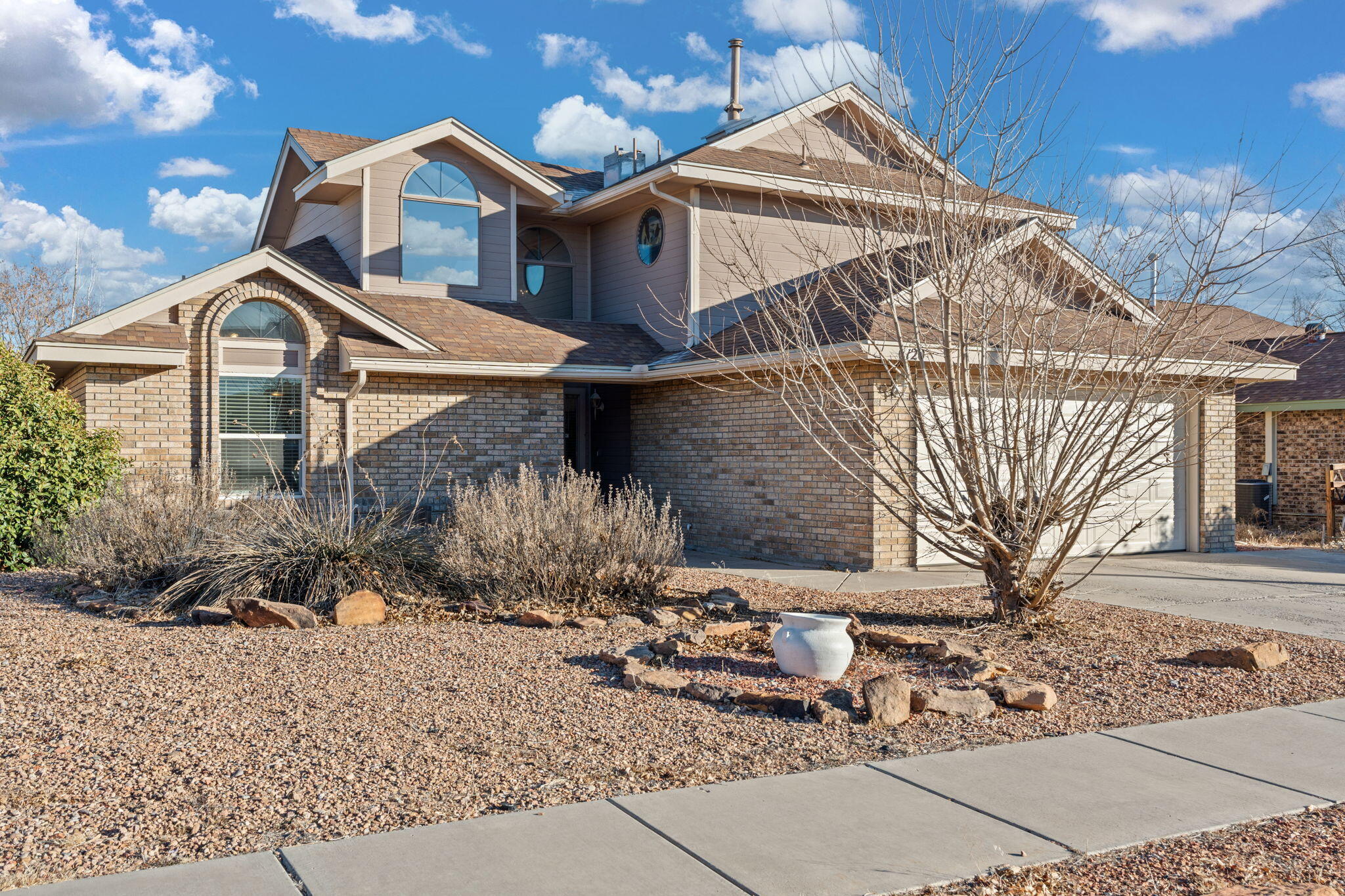 Welcome Home! This beautiful brick home is ready for its new family!   Enter in the  main living area with vaulted ceilings and an open floorpan.  Two large bedrooms are downstairs and a private primary suite upstairs  with breathtaking mountain views from the bedroom and large balcony!   Updates within the last few years include refrigerated AC, new furnace, new water heater/water softener, refinished kitchen cabinets and a TREX balcony off the primary.  The kitchen is bright and open to the dining room with more mountain views while you sip your morning coffee!   See this one today!