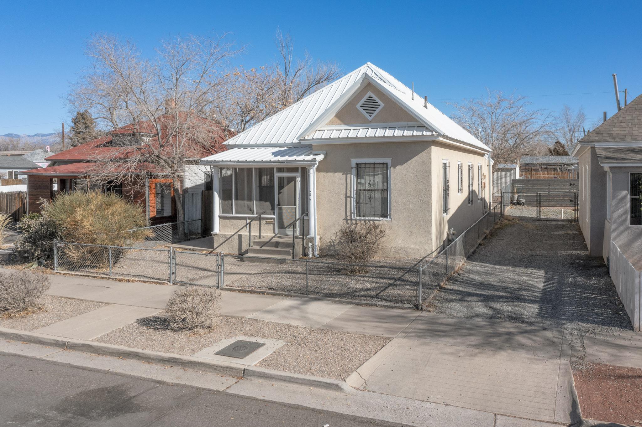 This Victorian style home has been lovingly maintained by the same family for the last 65 years! You will feel the warm coziness as you walk through the front door.  Three bedrooms plus an office, two baths and plenty of off-the-street parking for 4 cars, a boat and a RV!  The backyard access is through the alley. Don't miss the 15 X 12 Tuff Shed in the back too!  Many of the high-ticket items in the home have been updated while keeping the original charm. For example, there's a metal roof, upgraded 200 amp electrical, low maintenance landscaping, and newer ''Master Cool'' for those hot summer days.  Located in Huning Highlands, near CNM, UNM, Pres Hospital, downtown and easy access to the airport via I-25. Come check out this beautiful home. It is a 10!