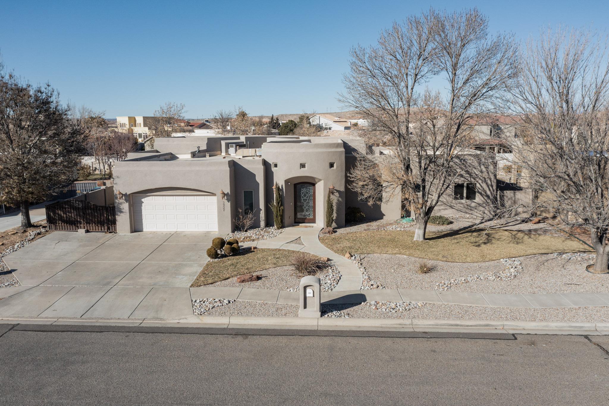 This impeccably maintained home  blends luxurious living with thoughtful design and high-end finishes. As you step through the custom stained glass entry door, you're immediately greeted by soaring ceilings, an abundance of natural light streaming through skylights, and the stunning beauty of 20-inch travertine flooring complemented by intricate decorative mosaic accents. The open-concept living spaces create a warm and inviting atmosphere, perfect for both relaxation and entertaining.  Kitchen features granite counters, functional bar area, see-through to family room, but best of all a mammoth pantry that is even fitted for laundry!  The family room is a perfect space for gatherings, offering a wet-bar with sink and even space for a wine fridge or keg-a-rator!