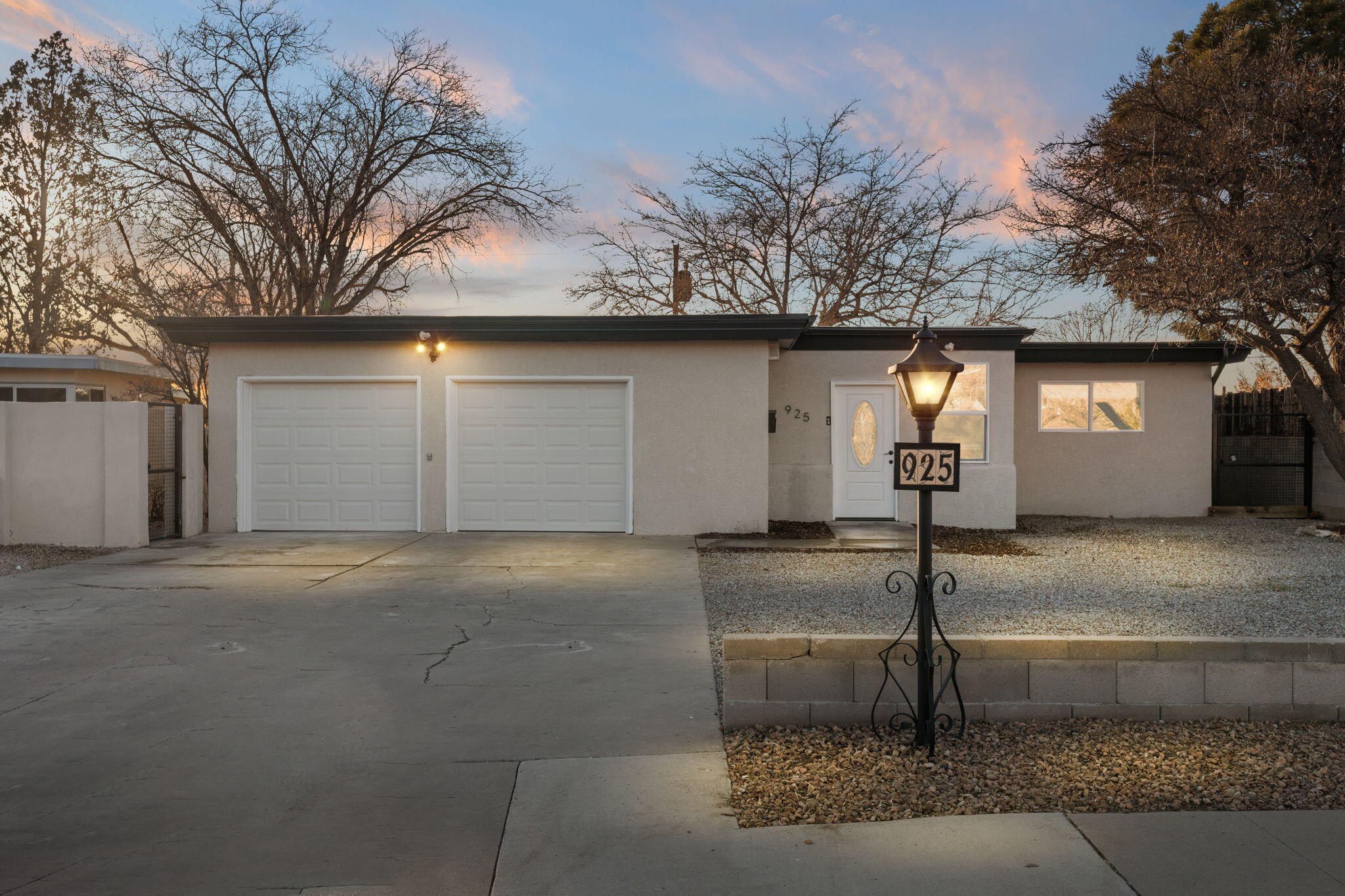 Beautiful Mid Century Modern home fully remodeled, situated in the  La Resolana community. Home features 2,550sf with 4 bedrooms, 2 bathrooms, 2 living areas and a finished basement. Spacious main living area with a stunning accent wall and wood burning fireplace. Kitchen with sleek gray cabinetry, granite countertops, stainless steel range, pantry and a breakfast bar with seating space. Dining area right off of the kitchen. Remodeled guest bath with dual sinks, a custom vanity, framed mirrors and a shower/tub combo with tile surround. Owners suite with walk-in closet and private bath. 600SF basement with a living area and separate entrance hosting a fireplace and a bedroom. Fully walled backyard! Close to UNM, shopping and restaurants! Refrigerated air!