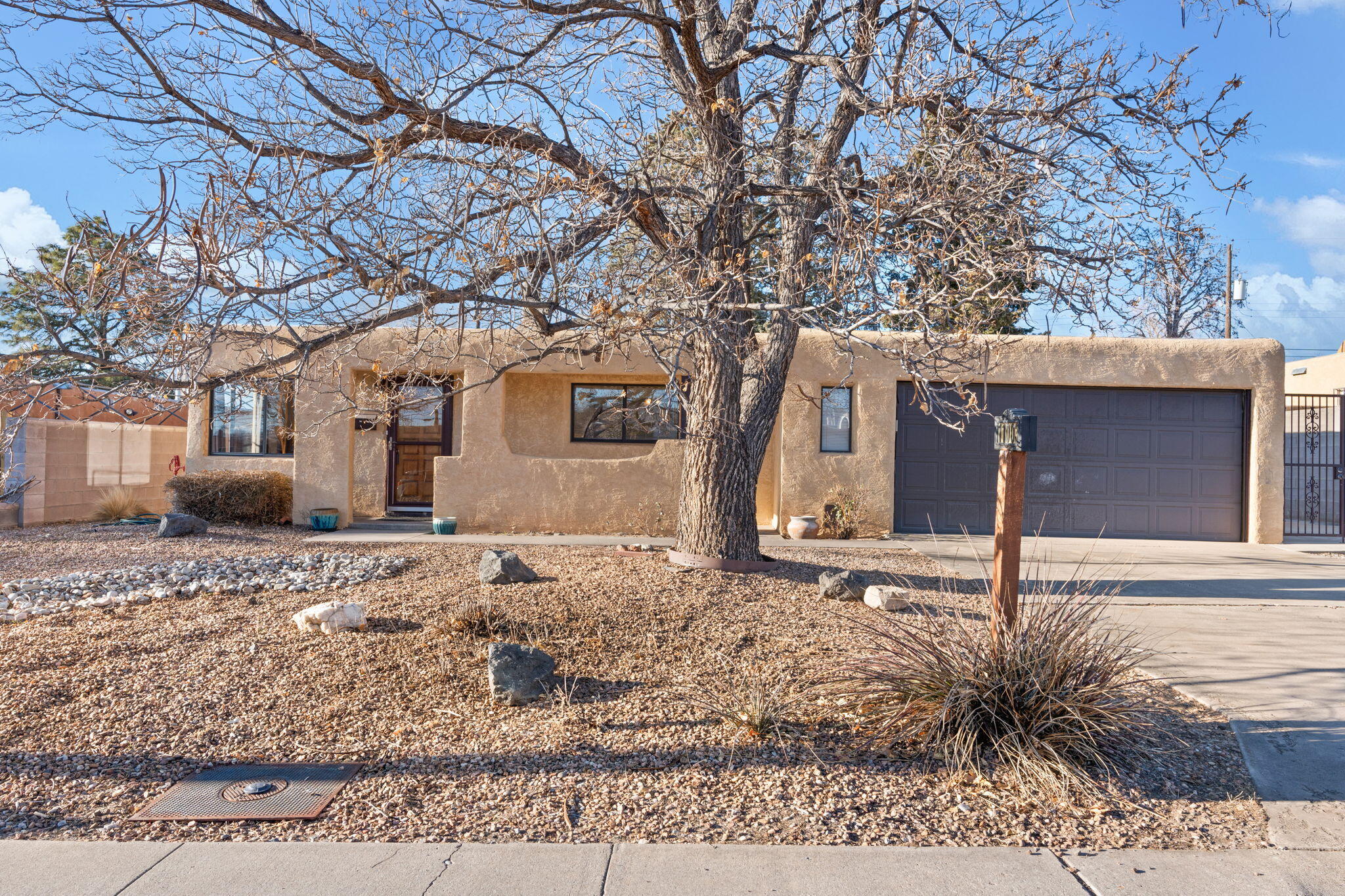 1 level, 2 car garage + side yard access!  Newer TPO roof (2024), newer mastercool, fresh paint on the interior & laminate flooring + tile (no carpet) throughout the home; this property is move in ready!  Open kitchen overlooks the dining room & wood burning fireplace. Walk-in closet in the primary + primary bathroom includes a renovated shower w/ subway tile surround.  2 well sized guest bedrooms share the full guest bathroom. Excellent sized backyard has a covered patio, lawn space, play structure, shed & a large, paved side yard which is perfect for your toys, boat, camper, etc.  The bonus room is a perfect secondary living space/office/home gym or a massive 4th bedroom. Minutes from Uptown w/ easy access to grocery shopping, restaurants & parks.  Schedule your private showing today!