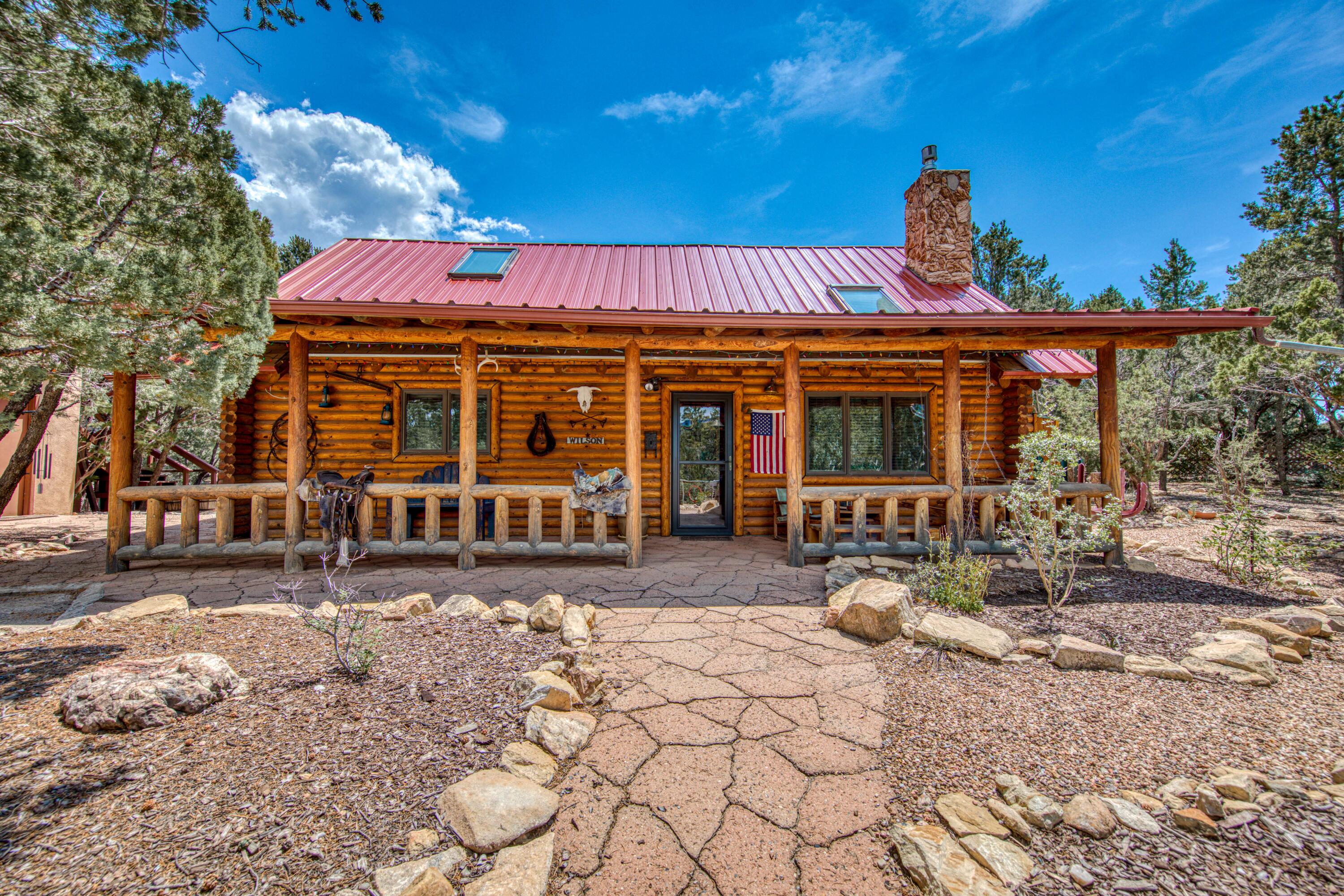 Welcome to your own private retreat with this stunning Log Home, nestled on a sprawling .73 acre lot surrounded by Pinon trees and breathtaking views. This property features a charming main log home with rustic finishes, a cozy living area, and a spacious kitchen perfect for entertaining. The guest house offers additional space for visitors. Enjoy peaceful mornings and stunning sunsets from your private outdoor deck. Enjoy working on projects in the outdoor studio while being surrounded by so much beauty. Don't miss the chance to own this piece of paradise! Schedule a viewing today!