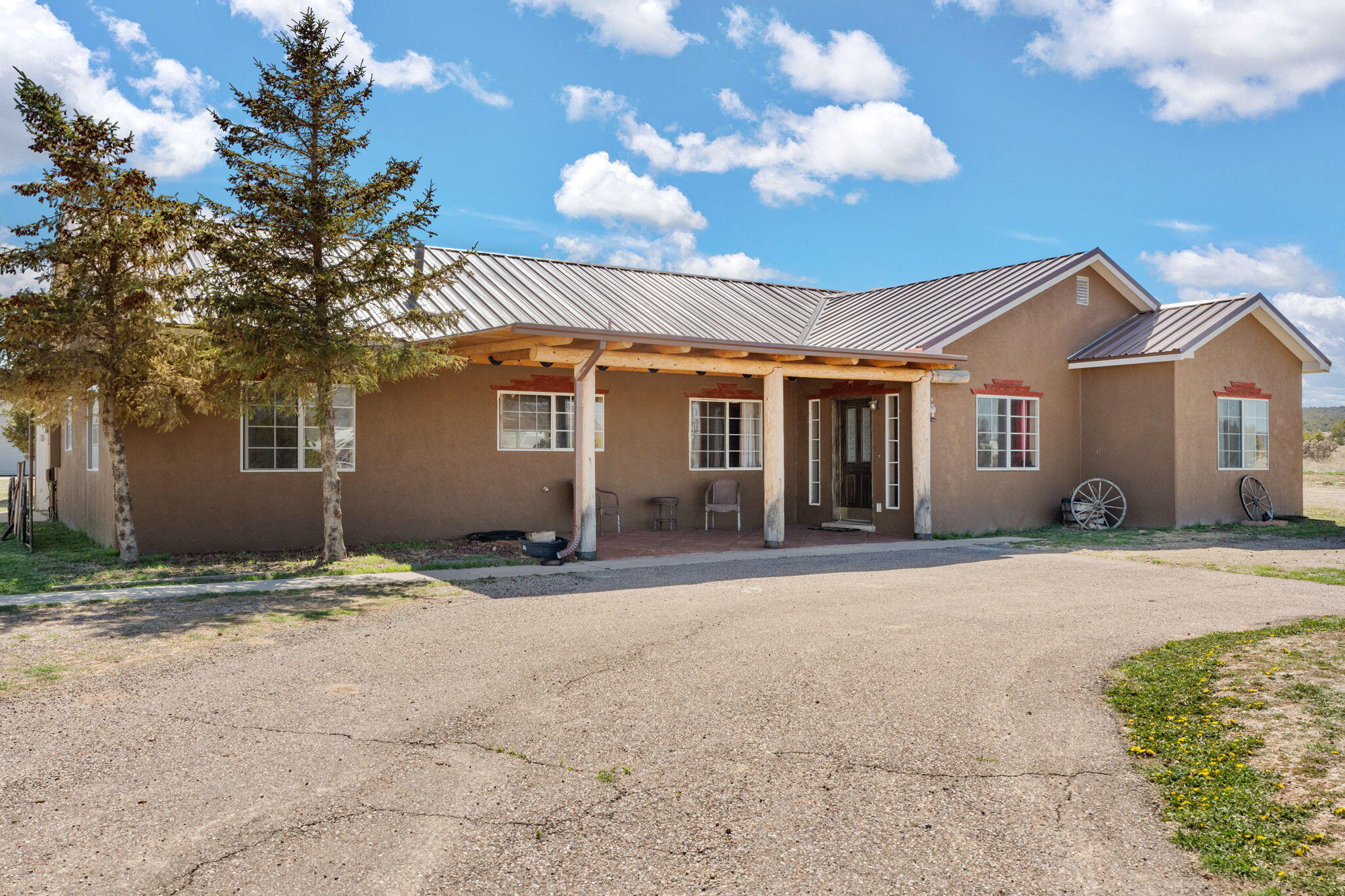 This stunning 4-bed, 2-bath southwestern ranch home on 5.1 fully fenced acres with an indoor arena is a horse lover's dream! The spacious kitchen features stainless steel appliances, granite countertops, and vigas on the ceiling. The cozy living room has tongue-and-groove ceilings and a gas stove. Radiant in-floor heat ensures comfort throughout. The master suite includes a luxurious bath with a Jacuzzi tub and double-head shower. The property also has a heated sunroom, backup Generac generator, and horse facilities, including a 66' x 80' indoor arena w/ entire east side ''hangar'' door that opens up to outdoor arena, 5-stall horse barn, multiple turnout pens, a 40' x 60' shop and 2 RV plug-ins.