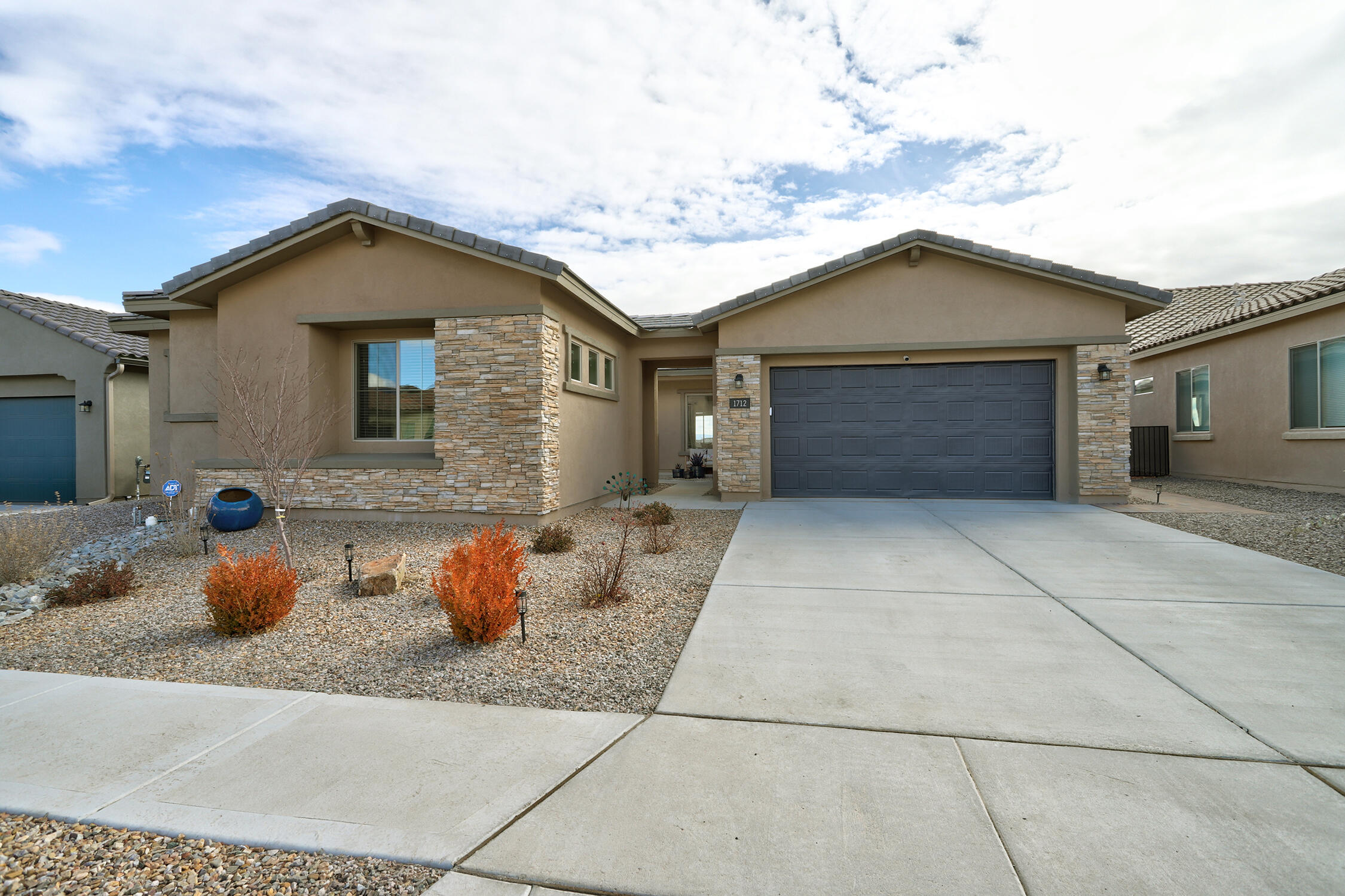 Qualifies for below market rate call listing broker for info. Incredible Single level home on an elevated VIEW lot in a gated community! Open, bright & poised to showcase the long- range views of the city & Sandia Mts. from the spacious living room that flows seamlessly to the chef's dream kitchen &dining spaces.   2 ensuite bedrooms, plus 2 additional bedrooms AND an office make this dynamite floor plan super functional. This gem has all the style and amenities you 've been dreaming of w/ soothing neutral tones and beautiful tile work.    Back yard is professionally landscaped and provides the perfect space for relaxation & taking in the mountain views.     Superb location offers nearby freeway access to make commuting to anywhere you need to be a breeze!  Neighborhood offers green space