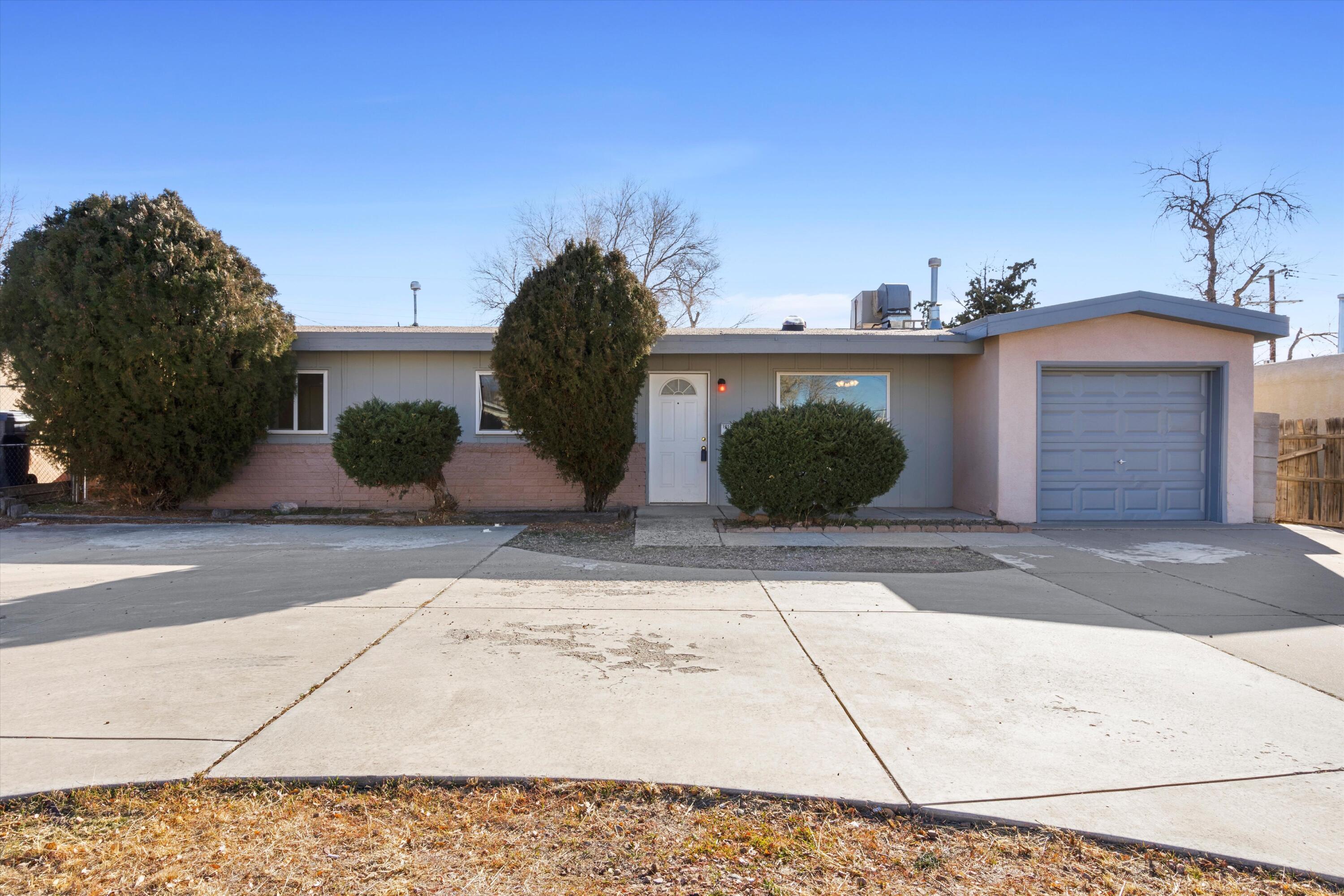 $5K seller credit to buyer with acceptable offer!!  Welcome to this exceptional Northeast Heights residence. This home boasts 3 bedrooms, 2 bathrooms, and two inviting living spaces, complemented by a spacious laundry room and an attached 1-car garage. The interior features fresh paint and new carpet, creating a contemporary and inviting atmosphere. The large kitchen is equipped with solid surface countertops, ideal for culinary enthusiasts, while the private backyard, with its raised walls and expansive covered patio, offers a serene outdoor retreat. Conveniently located near shopping, dining, and essential amenities, this property is perfectly situated for modern living. Looking for an investment property, run the numbers, this would make a great rental.