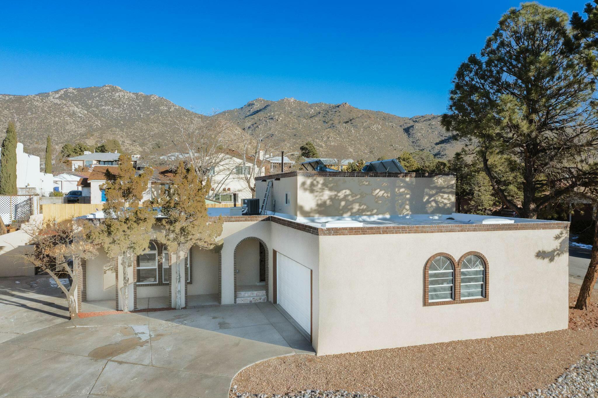Beautifully remodeled and move-in ready! This tri-level home offers an open-concept layout with 2 living areas and 2 potential primary bedrooms--perfect for families sharing space or creating your own private retreat. The heart of the home, the kitchen,showcases brand-new white cabinetry, top-of-the-line stainless steel appliances, and a stunning 9-foot granite island--ideal for entertaining. Enjoy easy-care acrylic wood flooring throughout--no carpet to clean! Bathrooms feature granite counters and custom tile work for a touch of luxury. Finished, oversized garage--freshly renovated and spotlessly clean, ready for parking, workshop, or gym.Updates include Refrigerated air,200 amp service,LED lighting, closet organizers fresh stucco, and low-maintenance xeriscaping.Schedule your showing today