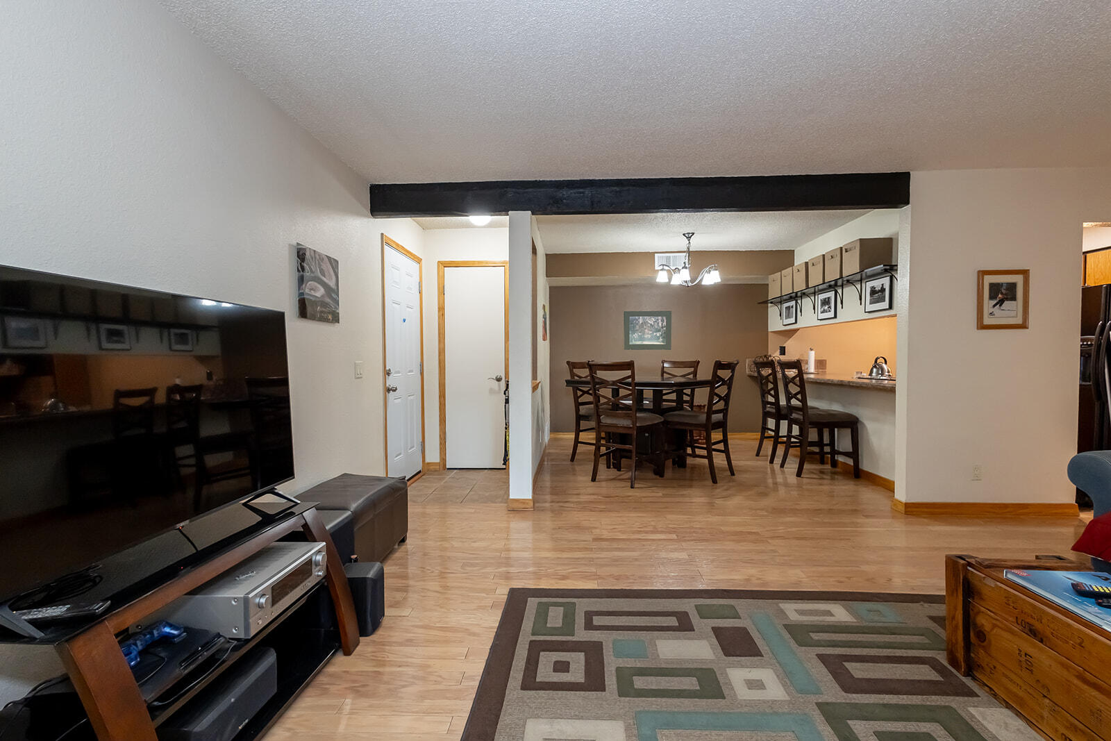 Discover this charming move-in-ready condo that combines convenience and comfort.  This ground-level unit features beautifully renovated bathrooms and fully equipped stylish kitchen with all appliances including the washer and dryer to remain. Hardwood floors flow throughout, enhancing the inviting atmosphere with a cozy wood burning fireplace complemented by solid pine wood doors. The updated windows, along with a newer HVAC system featuring refrigerated air, to ensure year-round comfort. A spacious 10x15 private fenced patio, can also be used as a private entrance.  The HOA covers most utilities and amenities, including gas, water, sewer, trash, a sparkling pool, sauna, clubhouse, playground, security gate, security personnel and property insurance.