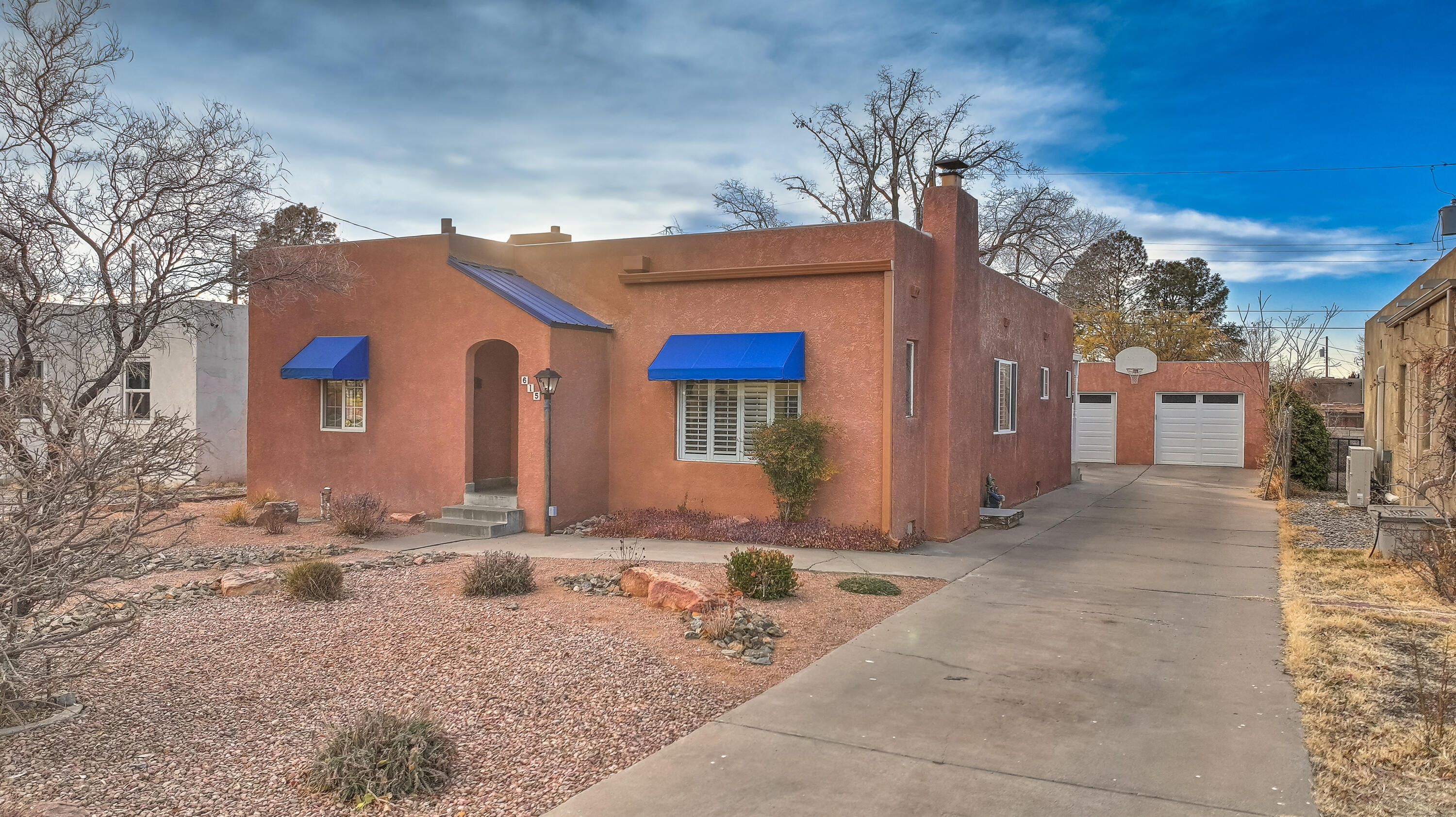 Super cute, well maintained home in UNM area. Same owners for close to 30 years. Gorgeous hardwood floors, cozy wood burning fireplace, Beautifully redone kitchen with quartz counters and SS appliances (2020). Bedrooms are both generously sized. Bright sunny study, built in desk and storage with access to large deck and separate entrance. Refrigerated AC (2019), Furnace (2018) Studio has Minisplit (2020). Garage was a two car garage with a bay converted to the studio. One car garage now with extra storage and 220v outlet. See floor plan for layout of home.