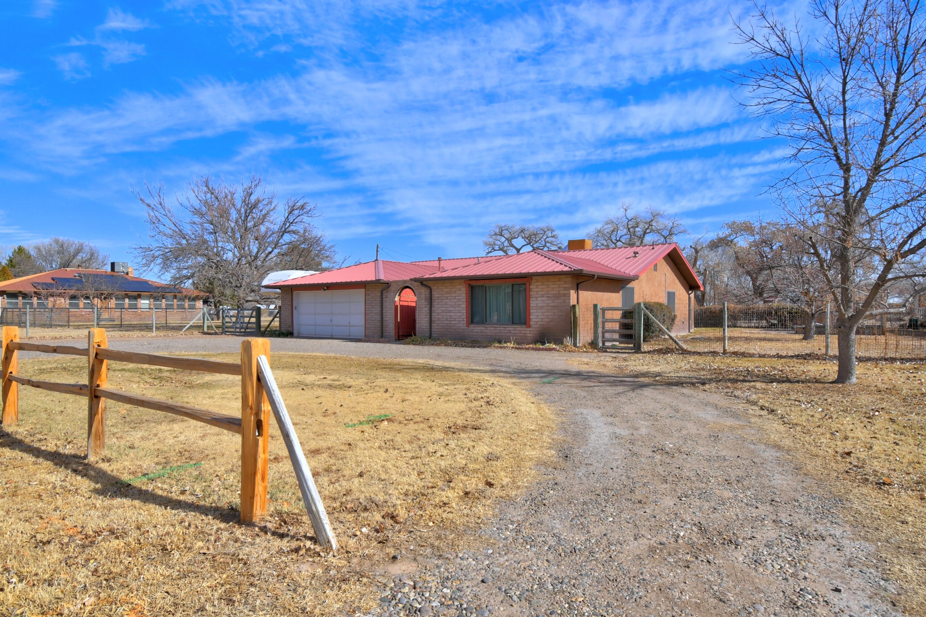 1 acre Horse property in Beautiful Bosque Farms.  4 bedroom 2 bath home on popular Green Acres Ln.  Lovingly cared for home with  sunroom, fenced back yard, RV spot with 220 electricity, main panel plug in for a backup generator, storage and more.  Community water and sewer service, natural gas and an irrigation well with auto sprinklers. The back half of the property is also fenced and features a 2 horse stall and storage.  Established trees and grass complete the landscape.