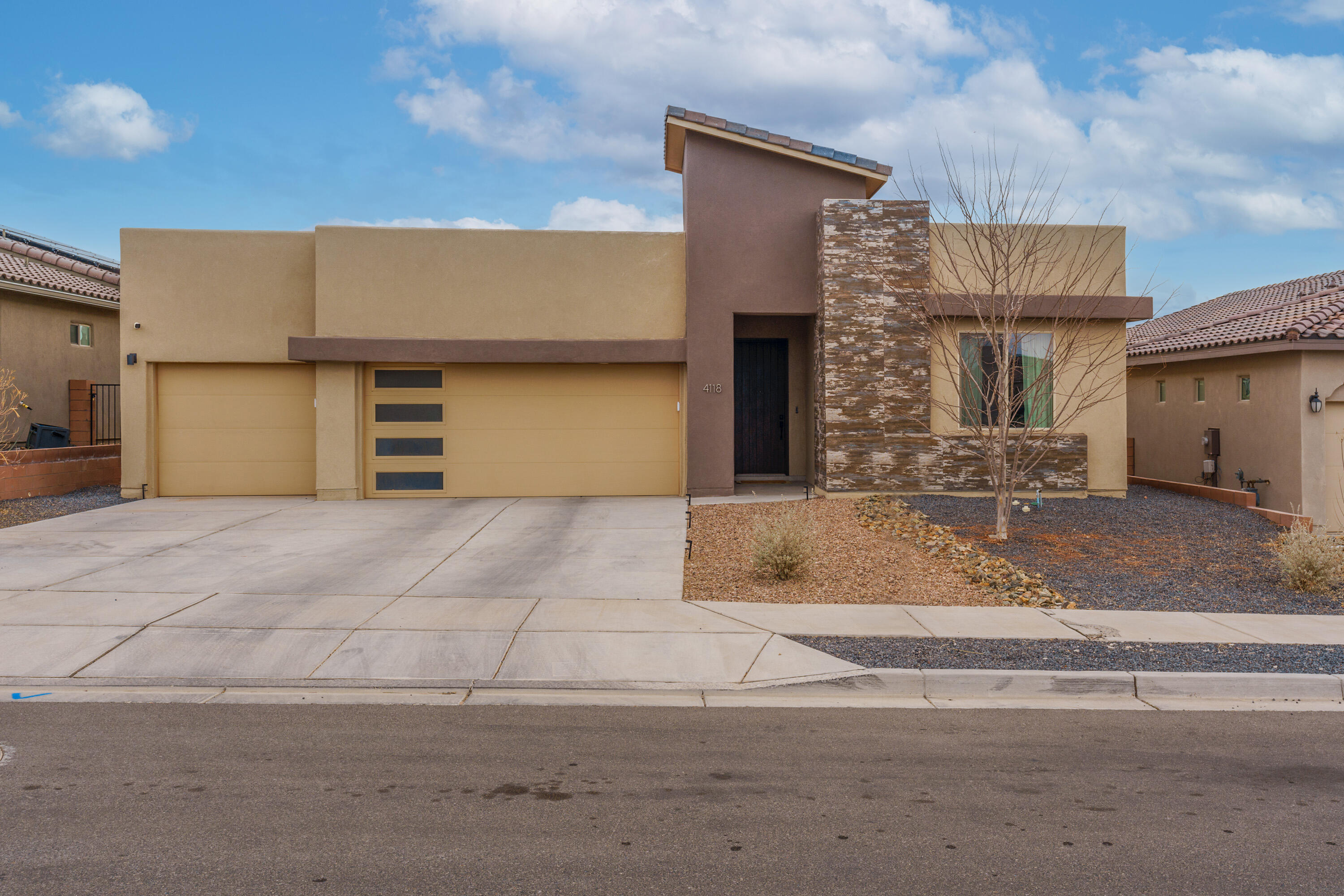 Modern home with beautiful design features. Open concept floorplan-kitchen open to the family and dining room. Raised wood beam ceilings, 8 ft doors, modern light fixtures, modern sleek tiled fireplace, upgraded 5'' baseboards, and upgraded tile floors among the many features. Granite counters,  charcoal colored cabinets, sleek backsplash, large island with bar seating, Whirlpool SS appliances, pot filler over gas cooktop complete this gourmet kitchen. Spacious primary suite with glorious bathroom including a walk-in tiled shower & double vanity. 2 additional bedrooms plus a flex room-den, office or 4th bedroom with French doors and closet. Full hall bathroom and additional powder bath. Covered patio, mountain views, and ready for your creative landscape ideas. 3 car garage!