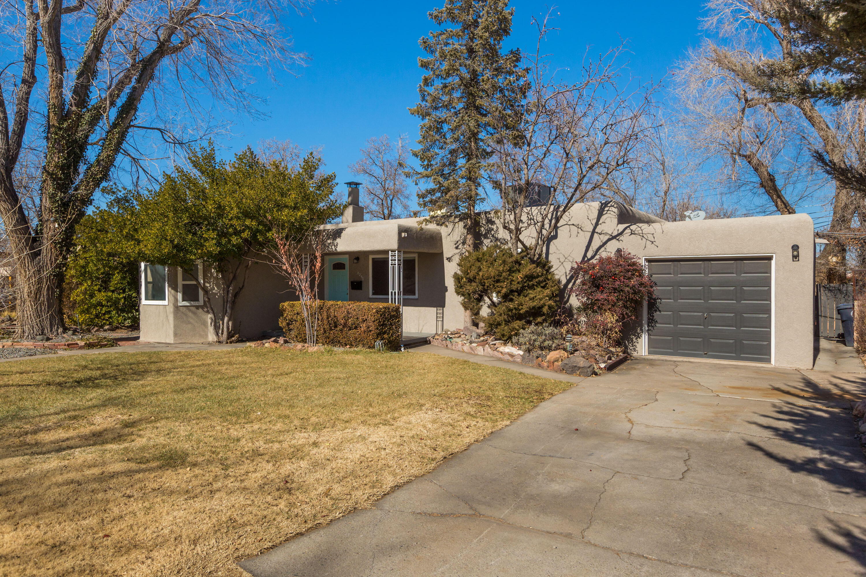 Tons of updates over the last five years in this incredible location near UNM and Nob Hill. Right around the corner from Humble Coffee, this house offers two living areas, 2 fireplaces, skylights, a huge primary bedroom with space for an office, nursery or dressing room in addition to the over 80 foot walk in closet. Two other bedrooms and the huge family room make for lots of options, not to mention the large laundry room which could be used an office or pantry. Turf and a patio in the back for a nice clean and charming backyard. The house had a ton of updates in 2021 including heating and cooling, electrical, paint, floors, kitchen, windows and more. Come check it out today!