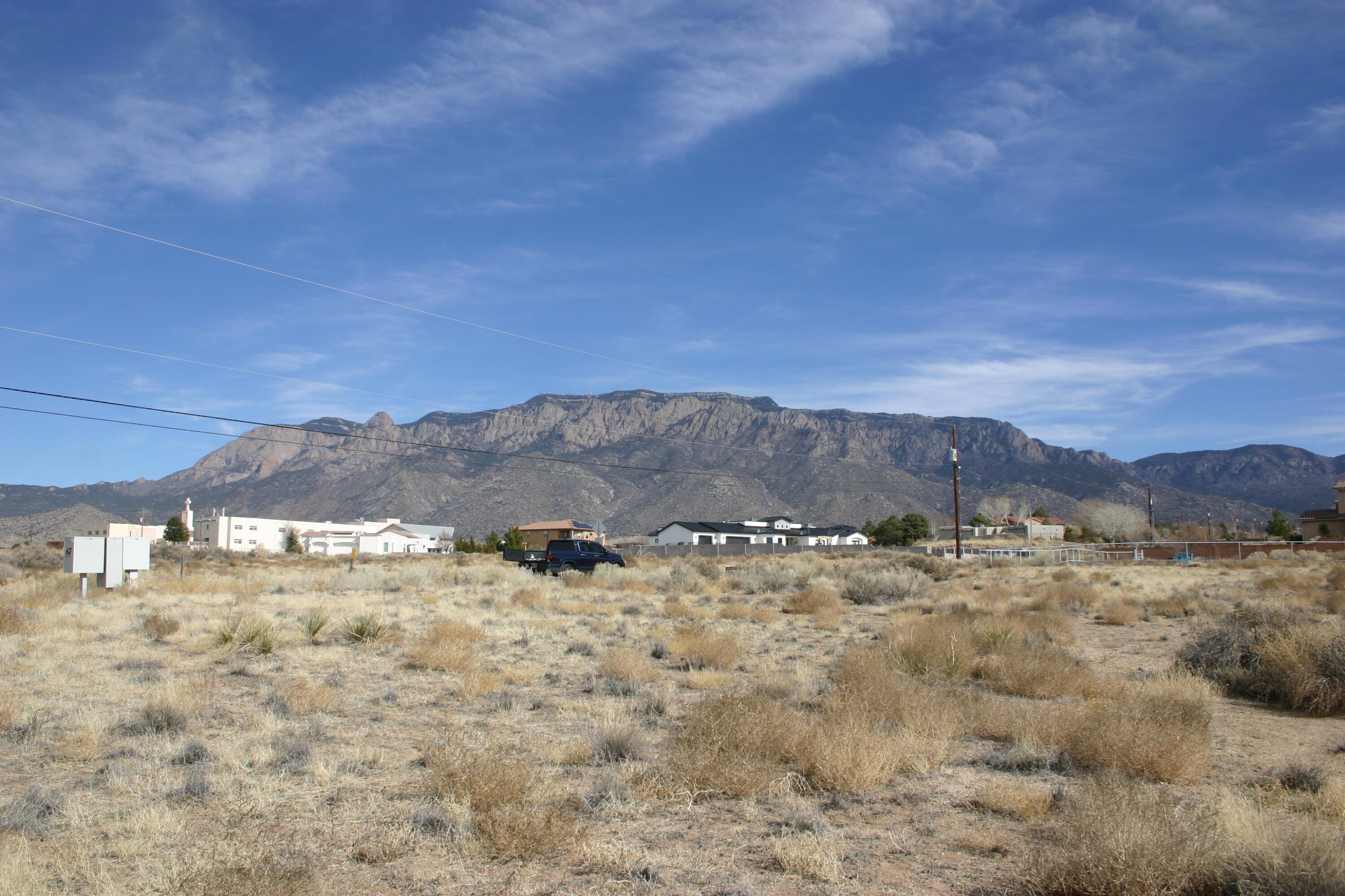 South of Paseo del Norte NE, close to town to the south, or west for the booming Paseo corridor shopping and more.  Excellent mountain views, westerly views too.   Adjacent homes mean power, phone, cable tv, natural gas.  Area outside municipal service area, everyone drills a well and has a septic system.  Will need some dirt work, drainage improvements, consult your builder or drainage engineer.   Lot to the west also available if you need more room for hobbies, horses etc.   Vista Sandia Equestrian Park just up the street.