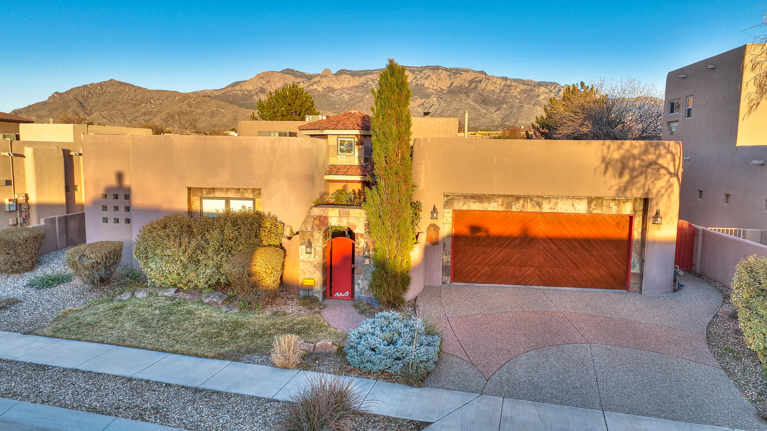 Extraordinary custom designed home offers a lifestyle that seamlessly integrates indoor-outdoor living with Sandia Mountain views. Elegant primary suite features dual bathrooms, large closet and has a flex room that could be a gym/office/bedroom. The office, plus 2 additional bedrooms are separated from the primary. Chef's dream kitchen for entertaining and preparing meals. This home has elegant art touches including glass art steps, stained glass windows, barrel high ceiling in the gallery/hall, large viga beams, herringbone ceilings in the living room & carved viga posts. Escape outdoors with two peaceful spaces including the landscaped backyard with views and inner courtyard. Located in La Cueva School District and the gated Desert Ridge community this is an exceptional home.