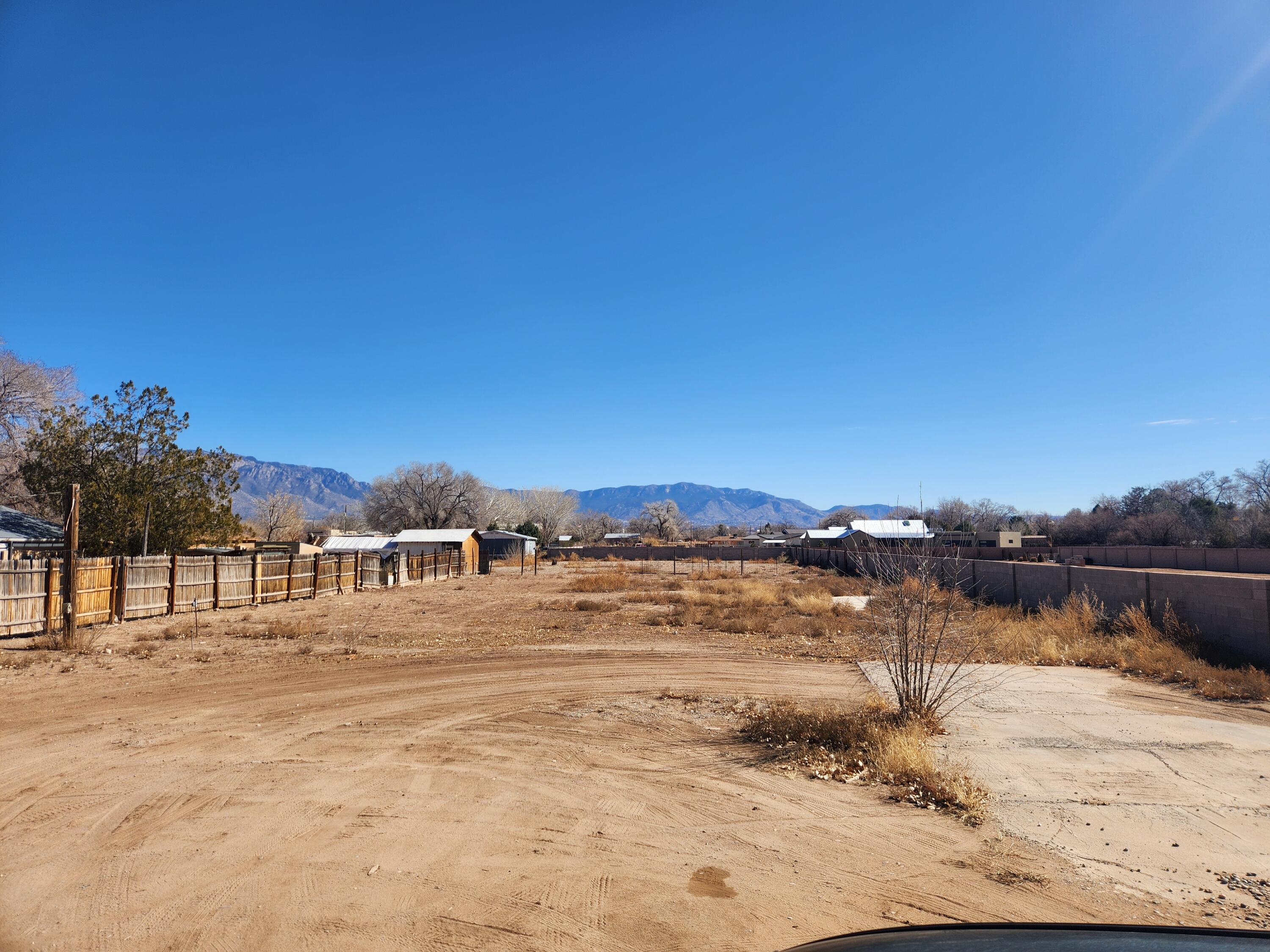 Opportunity awaits with these two adjacent, L-shaped lots offering a total of .96 acres in the highly sought-after area near Los Ranchos de Albuquerque. View of the beautiful Sandia  mountains. Perfect opportunity to build your forever home. 2 Lots adjacent to eachother! 1035 and 1037 Ortega rd.