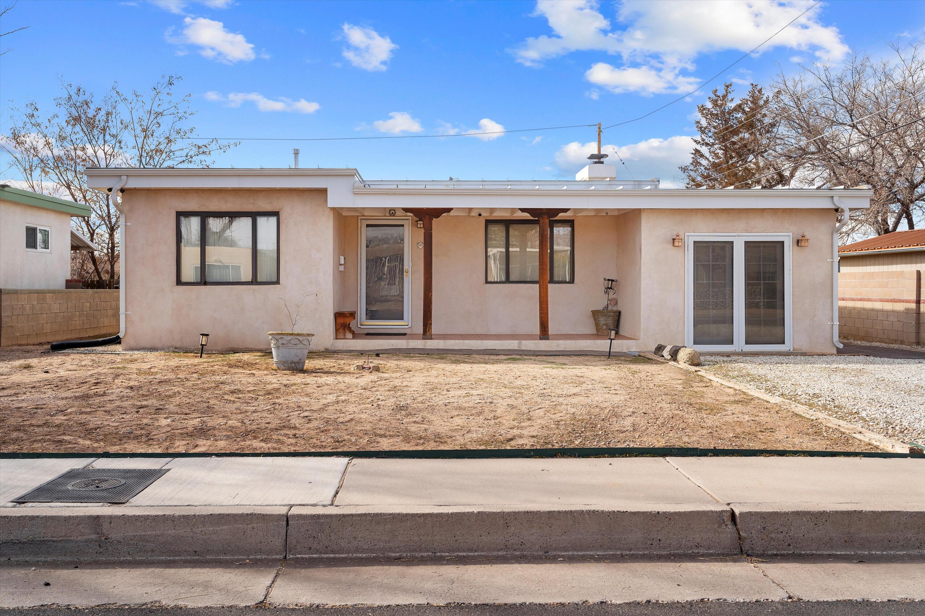 Investment opportunity. This cozy 2-bedroom, 1-bath home offers a comfortable living space with a dining room, living room, and family room, providing plenty of room for relaxation and entertainment. Conveniently located with easy access to shopping, I-40, and I-25, it's also close to Nob Hill, the University of New Mexico (UNM), and Kirtland Air Force Base. Inside, you'll find beautiful tile and wood floors throughout, adding warmth and character to the home. The large backyard is perfect for outdoor activities and includes a storage area for added convenience. This home presents a wonderful opportunity in a prime location! Additionally, there is a tenant in place with prepaid rent for the next 12 months at $1,850 per month . No vacancy period, making it an investment opportunity.