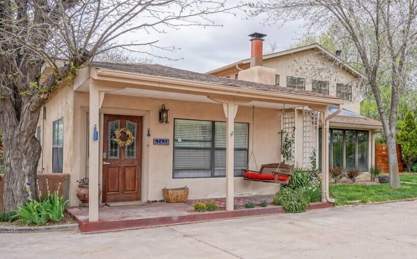 Charming home with Casita in the Greenbelt of Corrales! This home blends rustic charm with modern comfort. The main house offers 3 bedrooms, 2 baths, formal living with fireplace and dining, a cozy great room with French doors, and a loft with a sunset-view deck. The casita adds 2 bedrooms and 1 bath--perfect for guests or a private studio. The gourmet kitchen features granite counters and stainless appliances. The primary suite has backyard deck access, a private entry, and an updated en-suite bath. Enjoy the private location at the end of the lane next to the ditch along with Horse facilities, a dog run, a heated chicken coop, fenced gardens, a jacuzzi/spa and more which complete this rural oasis!