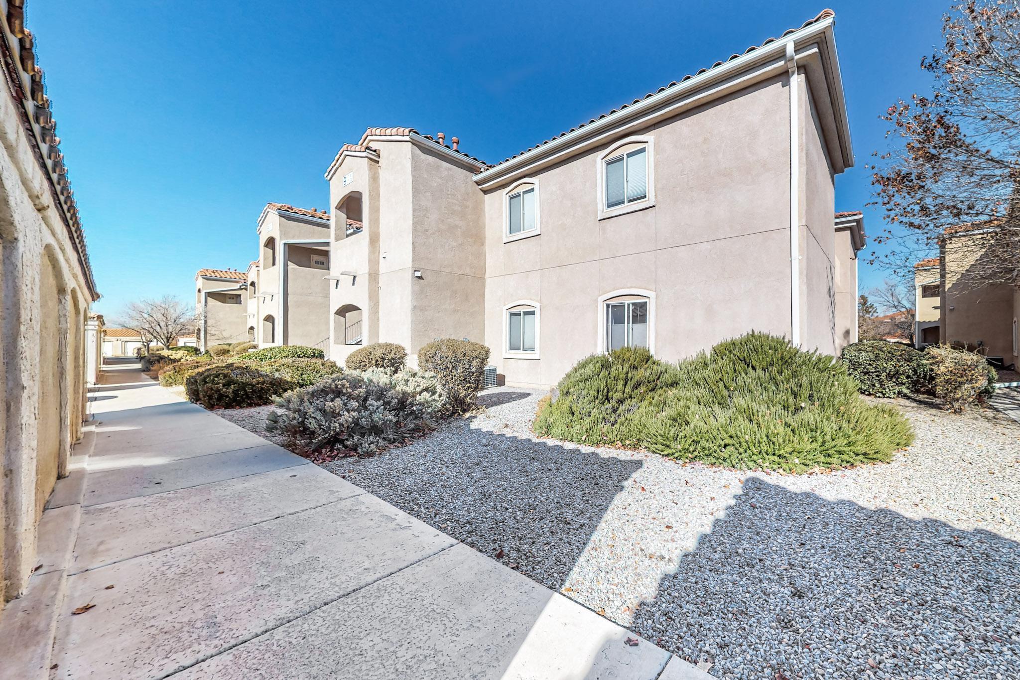 This charming 3/2 condo is nestled in the gated Rancho Mirage community. On the second floor of a four-plex, this unit offers a spacious layout with a bright living room that seamlessly connects to the kitchen and dining area. Step out onto the covered patio to enjoy stunning views of the Sandia Mountains. The generously sized master suite includes a walk-in closet, while the ensuite bathroom features an oversized shower and dual sinks. Each bedroom is outfitted with a ceiling fan for added comfort. The kitchen comes fully equipped with all appliances included, and a separate utility room provides ample cabinet storage along with a washer and dryer. This condo also features a detached single-car garage and an additional designated parking space, both conveniently located near the unit.