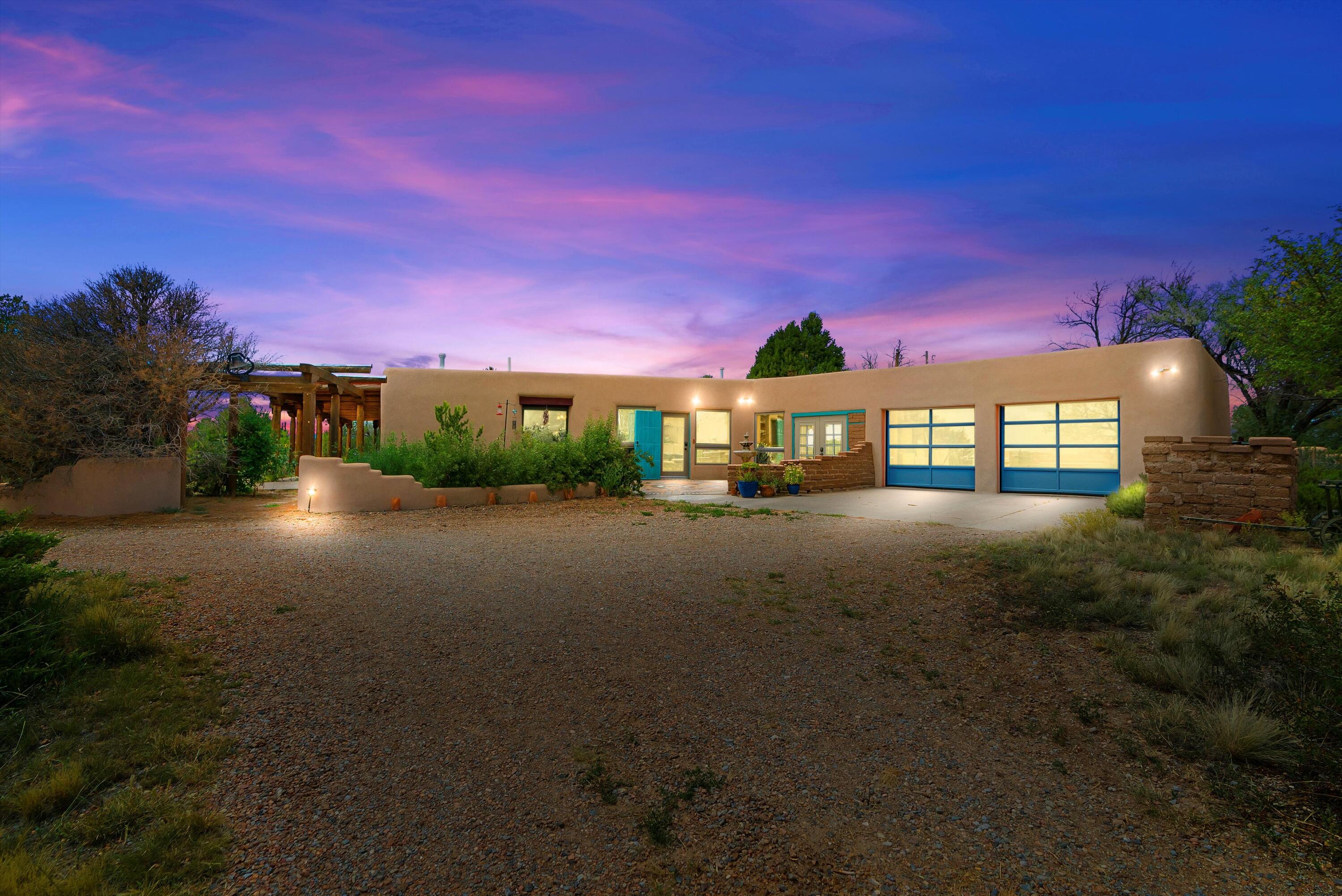 Discover the charm and essence of New Mexico in this custom home, set on a serene 7.5-acre lot. With 3-foot-thick walls, exposed viga beams, and pine ceilings, this home blends traditional craftsmanship with modern comfort. The expansive great room boasts cathedral ceilings, creating an open and airy atmosphere. The spacious bedrooms, versatile kitchenette, and large country kitchen with custom countertops. Enjoy the many outdoor entertaining areas to take in 360 degree views. A 2400sqft+ workhop provides versatily. Many more ammenities, a must see home!