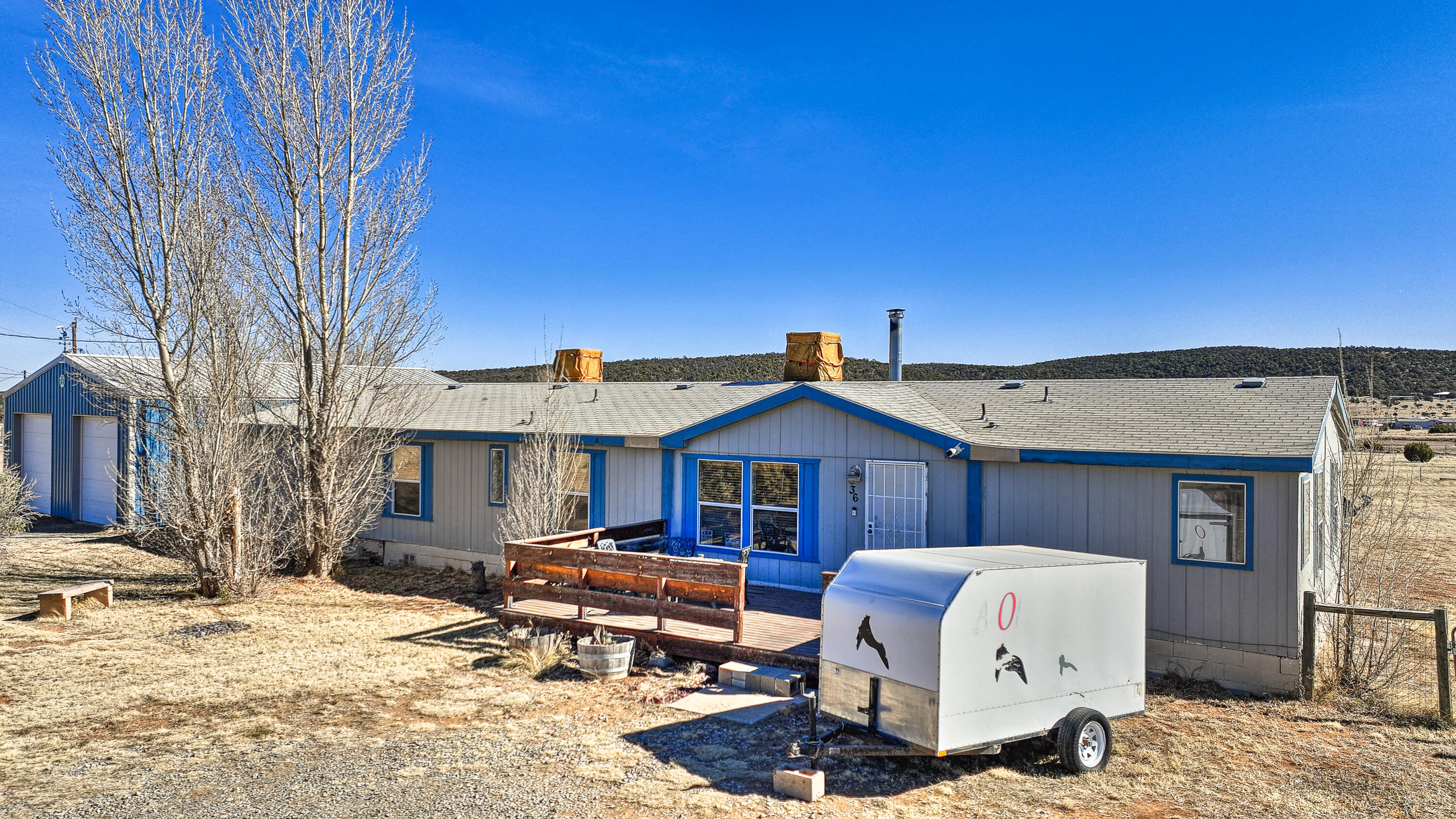 Welcome to 36 Los Chavez! This charming property is situated on 2.5 acres of  land, offering ample space and privacy. The detached garage is a dream come true for car collectors, hobbyists, and anyone in need of extra storage or workspace. Relax on the back patio and immerse yourself in your favorite novel, all while enjoying the beautiful New Mexico weather. Inside, the home features 4 spacious bedrooms, 3 full baths, and a large walk-in closet for added convenience. Stay warm and cozy by the pellet fireplace during those cooler evenings. Contact your favorite realtor today to schedule a private showing!