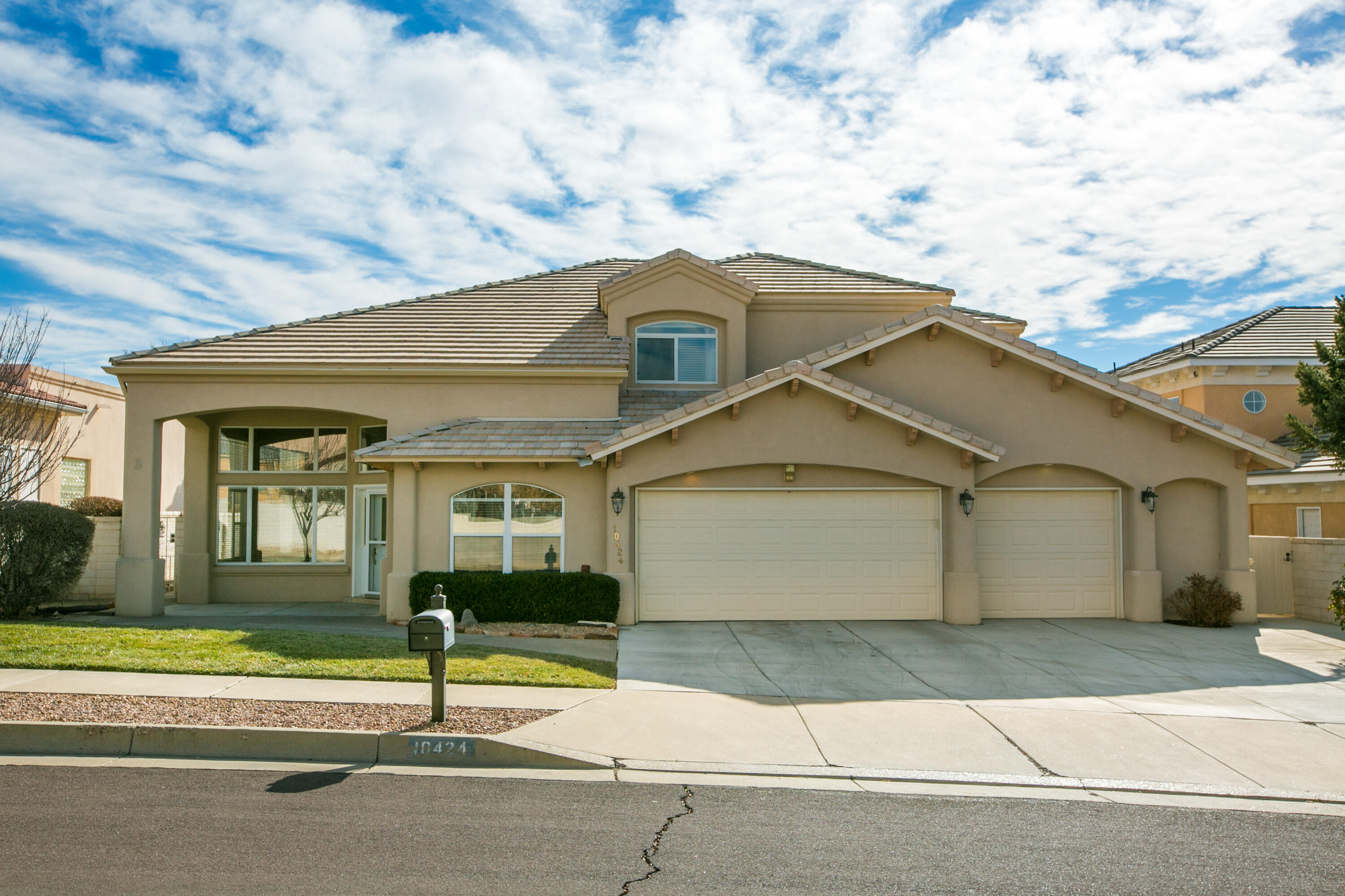 Great find in the coveted Estates at Tanoan! This home has been lovingly cared for by it's current owner and features a traditional floor plan with 2 living areas, 2 dining areas, a sweeping staircase, a main floor primary suite, and an office all on the main floor. Upstairs, there is a second primary suite with an en-suite bathroom, and two additional bedrooms with a jack and Jill bath. The oversized 3 car garage offers plenty of storage. Beautiful windows let in lots of natural light, and cathedral ceilings add to the open feel. The backyard offers great patio space for entertaining and is nice and private. Sellers recently replaced both HVAC units! This home is conveniently located in the NE Heights with quick and easy access to shopping, dining, great schools, and entertainment.