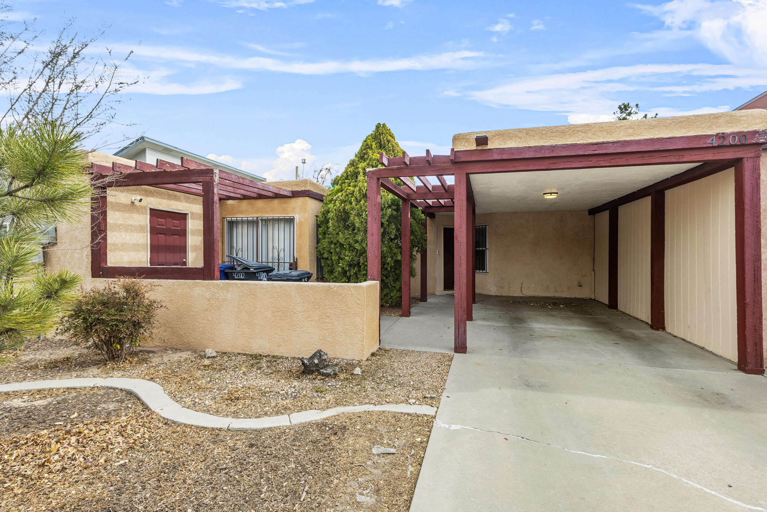 Discover this beautifully updated townhome, perfectly situated across from Presidio Park on Albuquerque's west side. Featuring a low-maintenance front and backyard, this home offers effortless living inside and out. Step inside to an inviting open floor plan, bright and airy kitchen boasts a cozy dining area. Unwind in the living room by the wood-burning fireplace, enhanced with a stylish new tile surround and rustic barn wood mantel. The spacious, private backyard provides plenty of room to relax or entertain. Move-in ready and waiting for you!