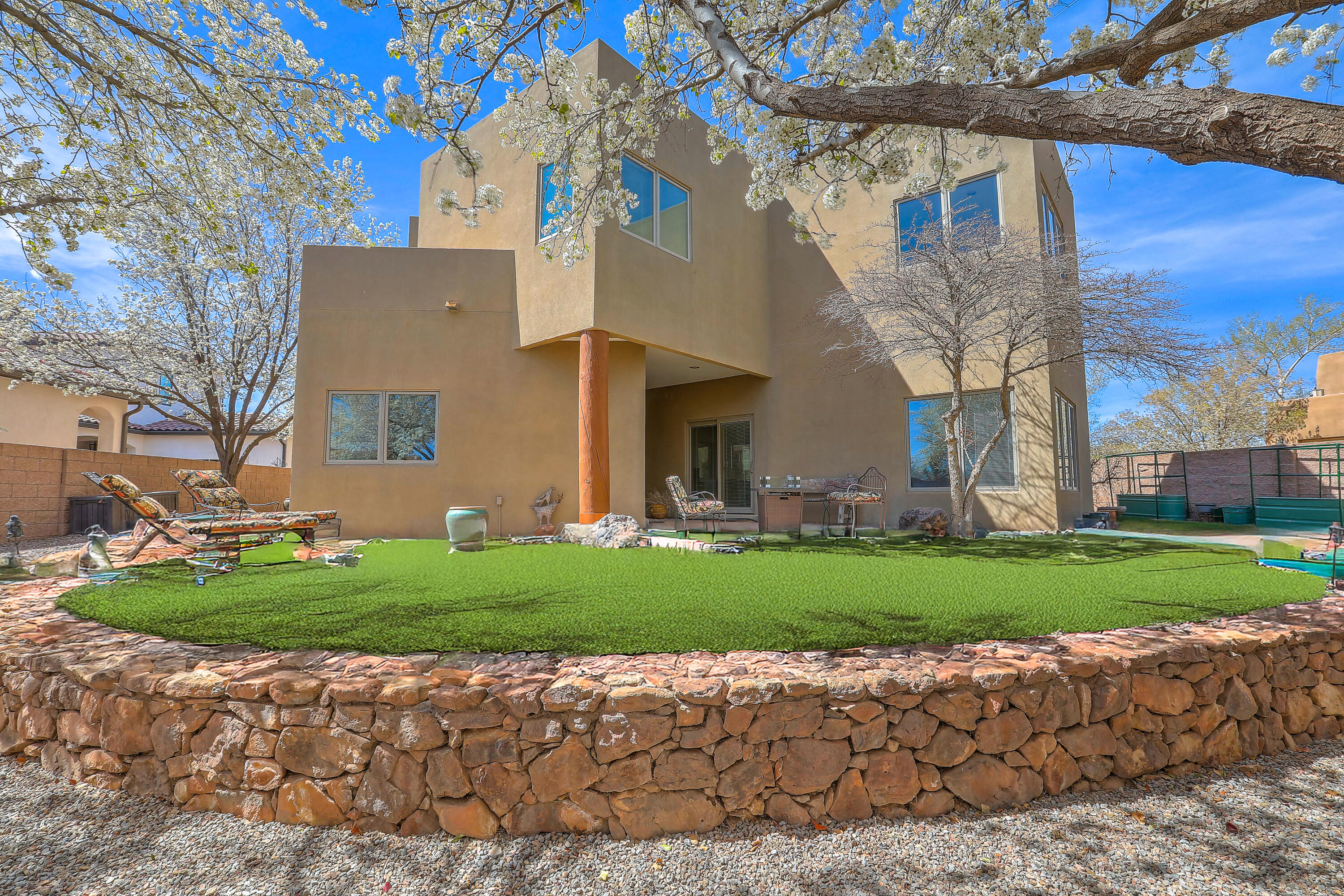 North Valley custom home! This contemporary Southwest beauty offers clean lines, open spaces, thoughtful design, blending modern elegance with natural elements. Large Pella windows flood the home with natural light, creating a bright, airy atmosphere. Slate tile flooring throughout main level adds sophistication, while radiant heat and refrigerated air ensure year-round comfort. The chef's kitchen is equipped with Dacor & Kitchen Aid appliances, granite counters, and more-making it ideal for cooking and entertaining. Primary suite retreat: spacious bedroom, cozy sitting area, spa-like bath & private balcony. Oversized three-car garage offers plenty of storage space. Located across from the Los Poblanos Open Space with easy access to miles of walking and biking trails! Take a tour today!