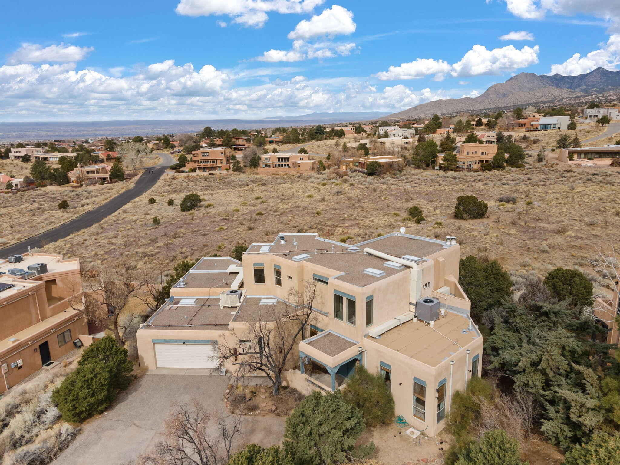 MOUNTAIN VIEWS! Beautiful home in Sandia Heights with unparalleled views of the Sandia Mountains! This thoughtfully designed home has 3 bedrooms, 3 baths + a study. The kitchen and a large view deck are on the main floor along with a large living room and fireplace. 2 bedrooms + a study are downstairs, with the primary suite, walk-in closet and viewing deck upstairs. The carpets are wool throughout the home and natural wood floors. Excellent school district, and close to hiking, biking, and beauty. Schedule a showing today!