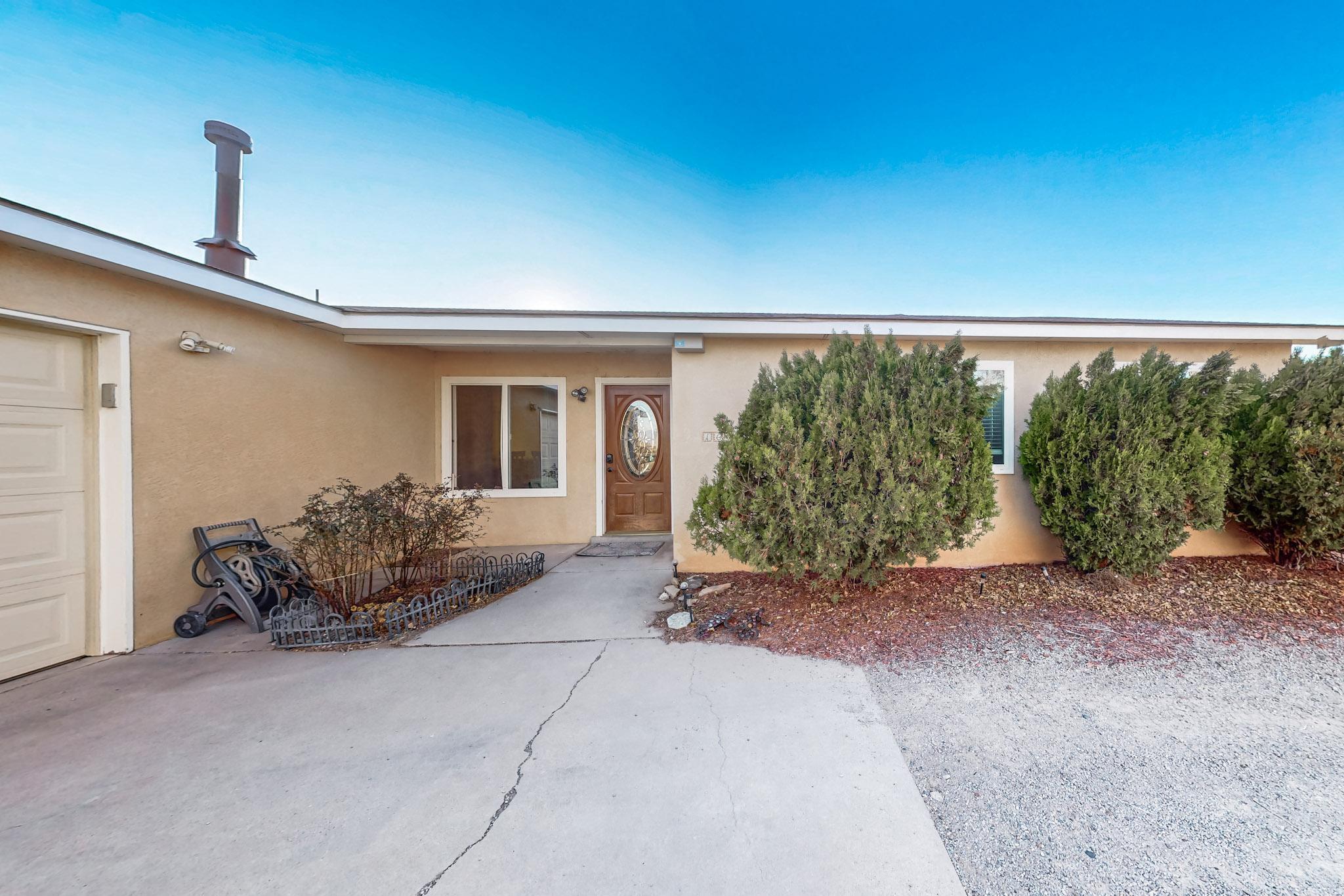 Sitting on HALF AN ACRE in Rio Rancho Estates, this spacious property is full of opportunity & unique features you'll love! MUST SEE 900 SQ FT WORKSHOP was used for owner's business. Use as a secondary detached garage (OVERSIZED), storage for recreational vehicles (ATVs, jet skis, etc!) or other equipment. PLUS it's fully equipped with electricity & wood-burning stove, allowing for year-round use. The home itself boasts a thoughtfully planned layout with multiple living areas, flex space, sizable bedrooms & a large laundry or mud room connecting between the kitchen & primary garage. Kitchen with SS appliances, range & breakfast bar overlooks the main living & dining rooms with a central wood-burning fireplace creating added warmth across this space.