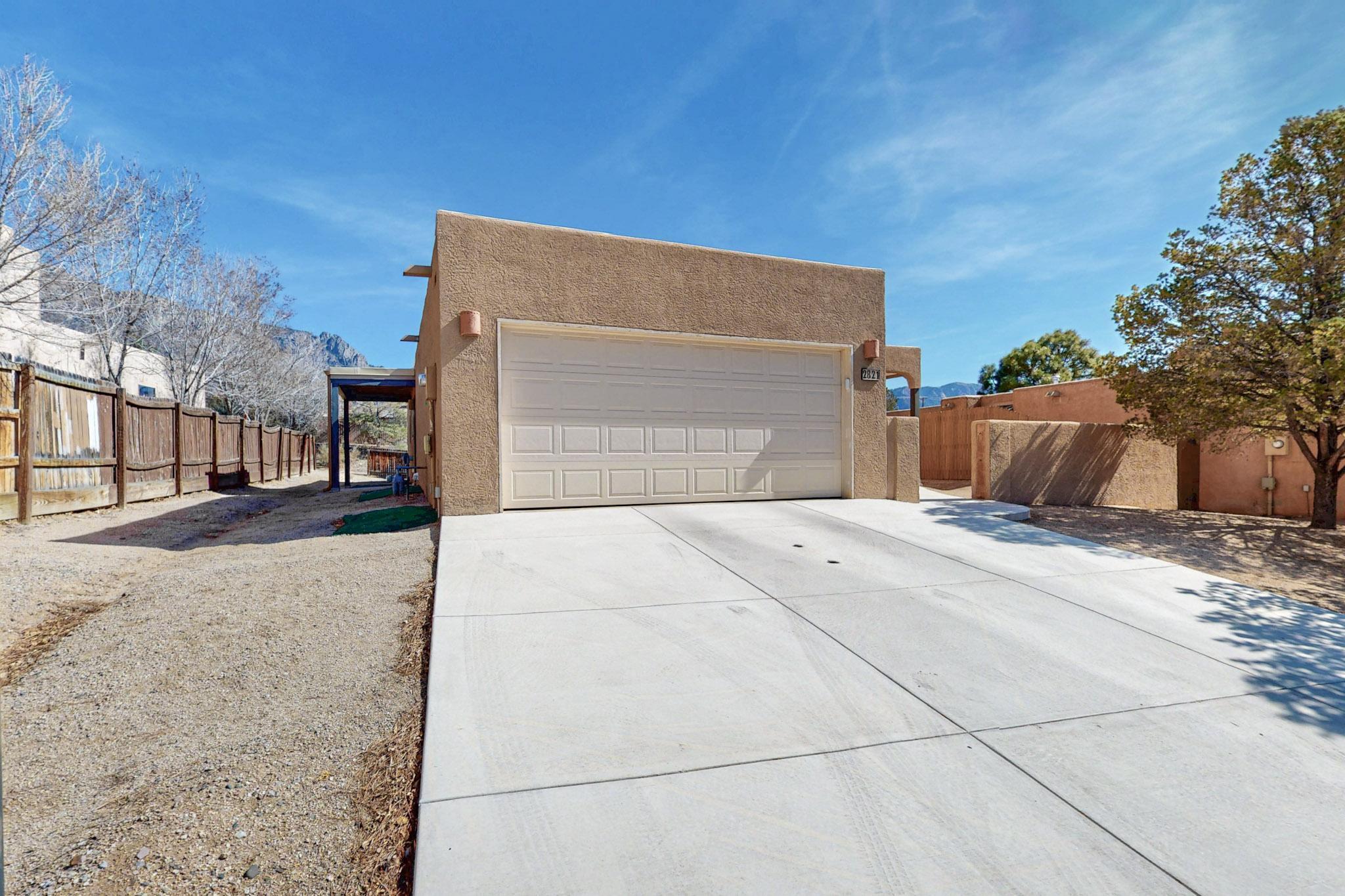 Step out of the back door to these stunning views of the Sandia Mountains! This gorgeous Sandia Heights home boasts high, tongue and groove ceilings with clerestory windows that allow the light to poor on in. Kitchen features beautiful ceramic tile, granite counter tops, plenty of custom cabinets for added storage, built in microwave, gas stove, side by side refrigerator, recessed lighting plus bar in kitchen offering even more cabinets. Generous sized Primary Bedroom with Primary Bath featuring walk in shower, beautiful tile and additional  hanging rod and cabinets/drawers for more storage. Full bathroom in hallway and two more bedrooms round out the interior of this charming home. Mechanical upgrades include Pellet stove fireplace, tankless hot water heater, refrigerated air and more.