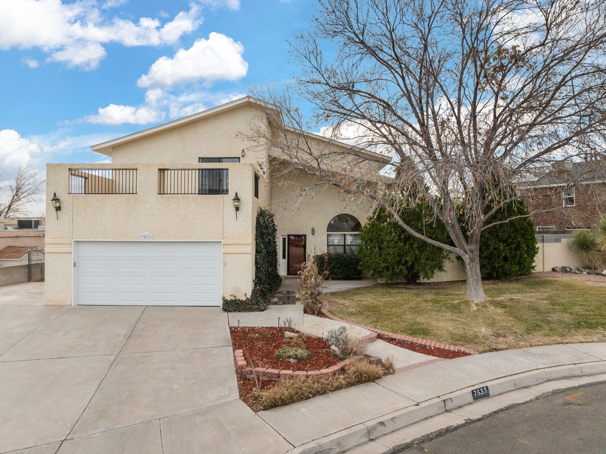 Sunsets, Sandias and City Views-you get it all with this exquisite Taylor Ranch beauty! Nestled in a peaceful cul-de-sac and featuring an extended driveway, this spacious residence welcomes you with high ceilings that create a bright and airy atmosphere. The thoughtful layout includes a formal dining area and two generous living spaces, one of which is highlighted by a stunning stacked stone fireplace. The open-concept design seamlessly connects to the kitchen, making this home an entertainer's dream! The Spacious Kitchen boasts an abundance of beautiful cabinetry, ample countertop space, stainless steel appliances and a perfect area for a wine or coffee bar! Downstairs you'll conveniently find a versatile hobby room/office or perfect guest room that is separate from the other bedrooms.