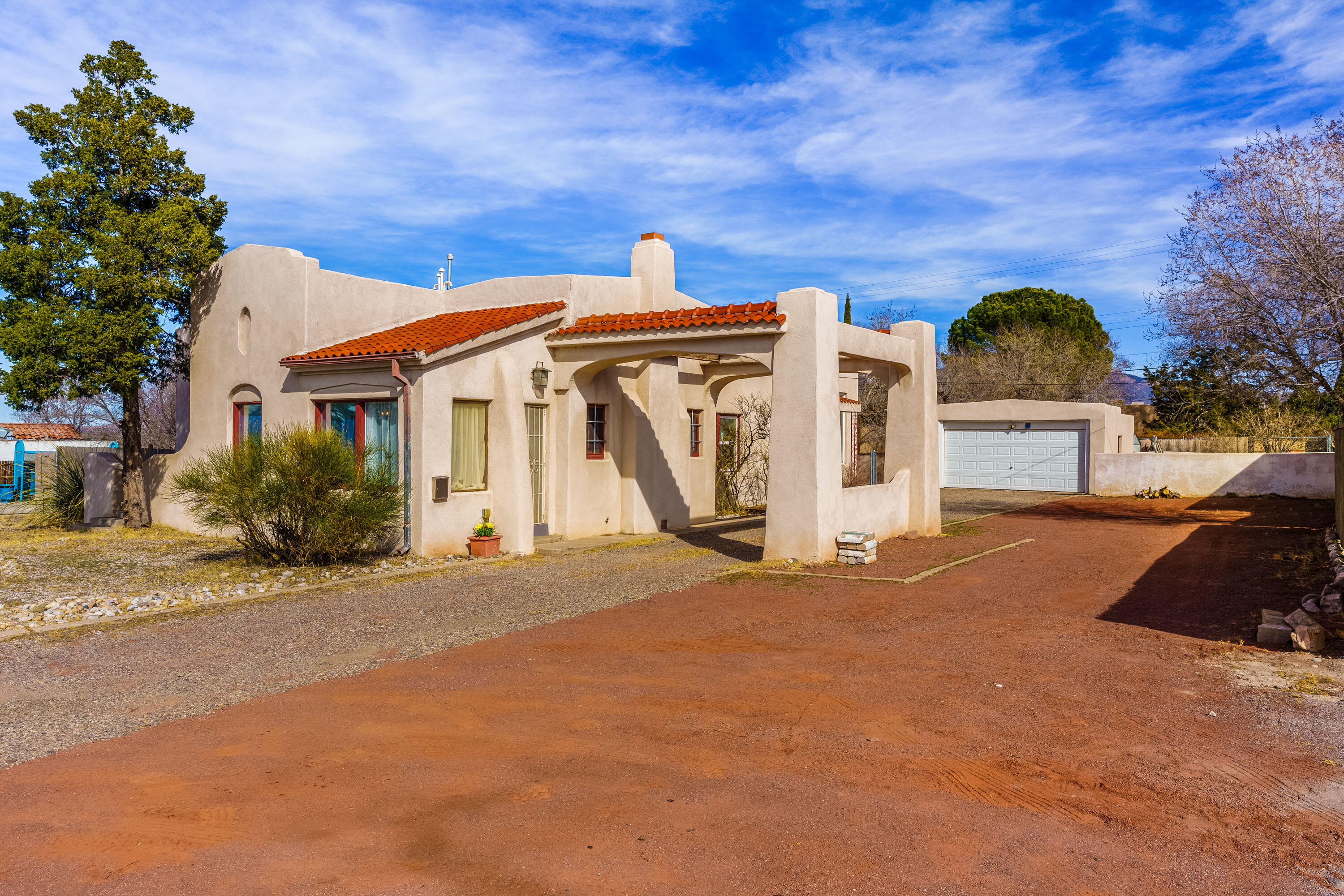 Live your dream in the heart of Nob Hill, the premier pedestrian neighborhood of Albuquerque. This 1920's light filled, gracious & spacious gem, has orig architectural elements. Stunning views of sunrise over the Sandia Mts & a colorful reflection of sunset on the mountain. This unique property offers a huge 539sf studio addition with 12' ceilings, 5'x7' windows perfect for work, or entertaining with a 2nd kitchen & 2nd fireplace. With 2 heat zones, 6 entrances, it can be divided into 2 units by closing the hall door. Zoning on the .31 acre lot allows for another structure. Landscape your privates yards. With tall parapet, build a rooftop deck. Possibilities! Easy access to Nob Hill cafes, dining, parks, boutiques, food co op, movies, breweries. Don't miss viewing this exceptional home!