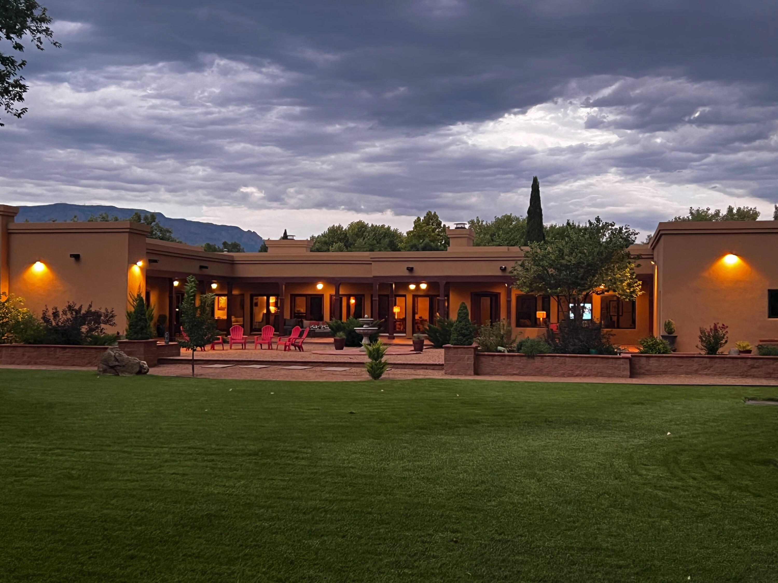 Exquisite New Mexico hacienda blends Santa Fe charm with current style- tucked away on 3.4 acres, the rural side of the gated Bona Terra community, a beloved luxury neighborhood. You will fall in love with the blend of current, comfortable amenities and character.  This fine quality construction boasts artisan design Spanish tile, gorgeous hardwood floors, wood beams, Pella wood clad windows, 3 brick Fireplaces, no interior steps! Brick floors & wood vigas wrap the covered portals on this classic U-shaped hacienda,  extending the living space. Amazing 6000sq ft of luxury living, gardens, mature trees, horse facilities, pedestrian/bike trails along the river! Three Private Water wells.  City water available.  See Video here: https://www.youtube.com/watch?v=jX2t25_k2r8
