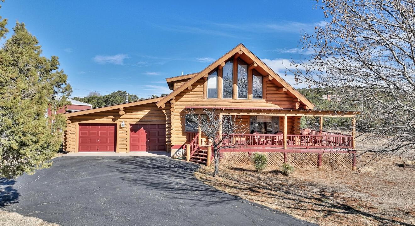 Your authentic adobe dream  log cabin is now available, only 25 minutes away.  Bring your horses, RV bus and boat the huge additional garage has room for everything you need.  Upgraded antique appliances and cozy pellet stove in vibrant red, the  primary bedroom on the main level,  nestled on 2 beautiful acres, snuggle up in the warm loft area.   3 bedrooms and an office or 4 possible bedrooms.  Simply Stunning!