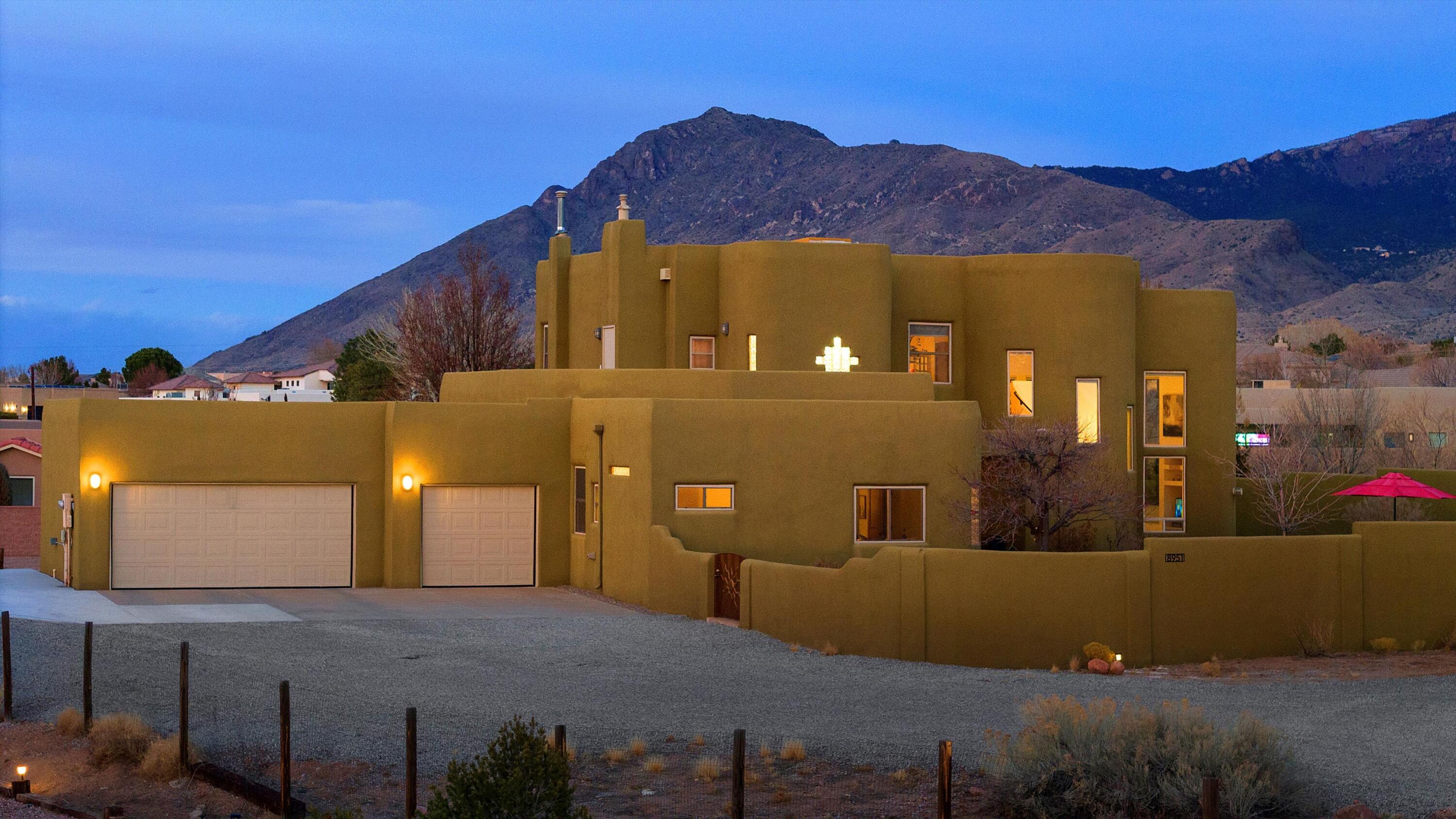 Stunning property in NAA offers breathtaking views of the Sandia Mtns to the east & Balloon Fiesta views to the west. It invites you in w/its circular drive, gleaming wood floors & tiled bathrooms throughout. The kitchen boasts granite countertops, Sub-Zero Refrigerator & Wine Refrigerator, SS 6-Burner Wolf Gas Stove & Kitchen Nook. Primary BR Ensuite features 2 balconies, double sink vanity, oversized soaking tub w/sep shower & walk-in closet. 2 downstairs BRs have a Jack & Jill bathroom, incl full bath w/dble sink vanity. The 2nd BR has its own entry door. 4th BR could also be an office or cozy loft. Oversized 3 Car Garage & an RV parking pad. This home combines natural beauty w/easy access to Albuquerque's amenities, perfect for those seeking a serene setting w/incredible sunset views.