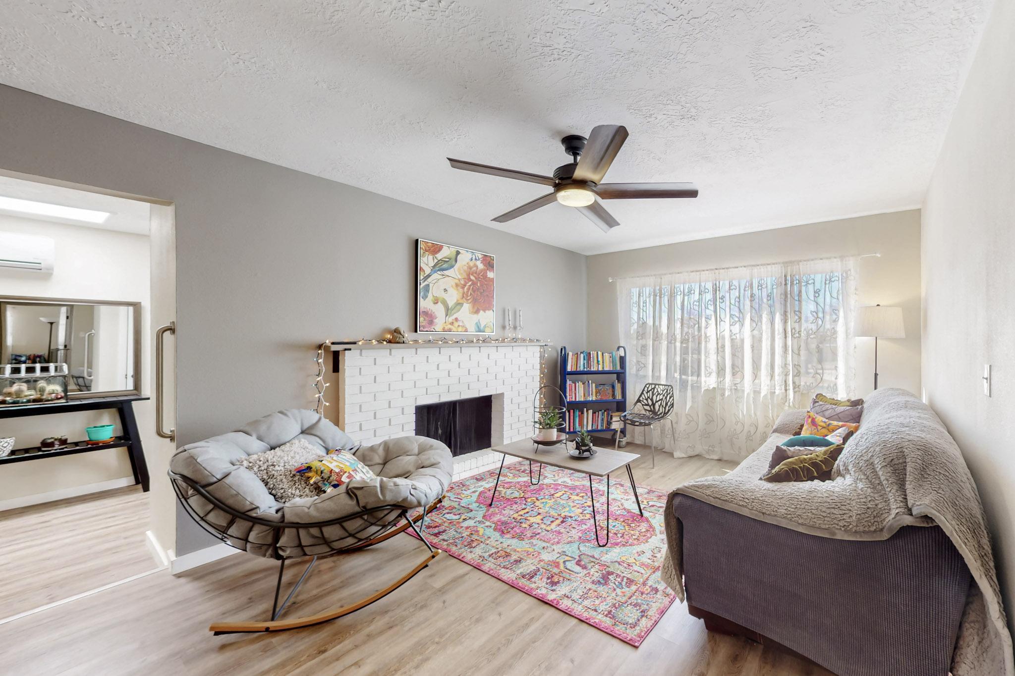 This lovely home is fully electric with an average utility bill of $10 per month (PNM) and No gas bill. Upgrades include New electrical panel, New solar. (Paid off by seller at closing $36K). Fully warranted energy efficient heating and cooling system Granite countertops, New water-saving Whirlpool dishwasher. Multiple living areas filled with natural light. Built-in bookcases. Beautiful vinyl Luxury laminate floors and new carpet in all bedrooms. Wood burning fireplace. and Spacious 2-car garage.    Schedule your showing today.