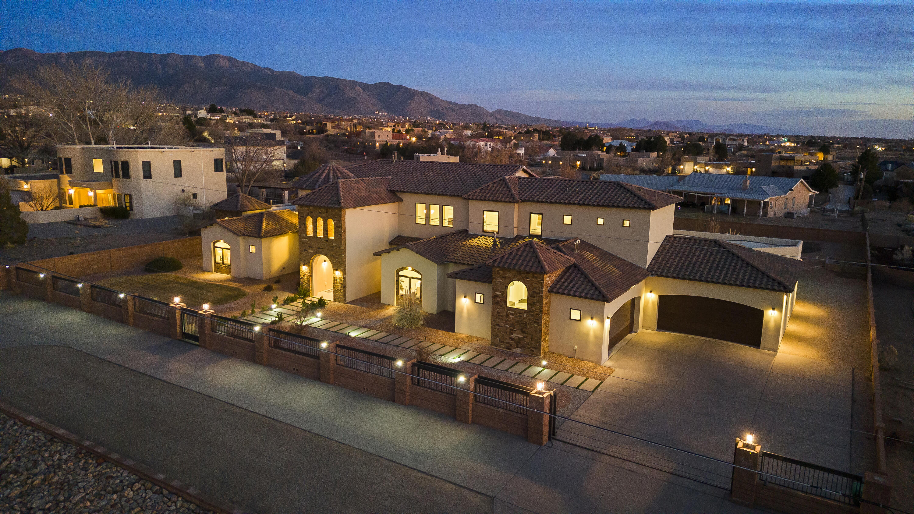 SELLER IS OFFERING an $80,000 SELLER CONTRIBUTION CREDIT TO USE ANYWAY YOU WANT!! This stunning 6240 sq ft custom built home nestled in the desirable North Albuquerque Acres. Constructed in 2017 this luxurious residence offers 5 spacious bedrooms, 6 elegantly appointed bathrooms, providing ample space for both relaxation and entertaining, movie theater room, private bar room, 4 car garage, two primary suites on both levels. As you step inside you, you'll be greeted by high coffered ceiling with beautiful venetian plaster, an open floor plan that seamlessly connects to living areas. The gourmet kitchen is a chefs dream, featuring top of the line appliances, custom cabinetry, large center island perfect for gatherings, The expansive primary suite  offers a private retreat with a spa-lik